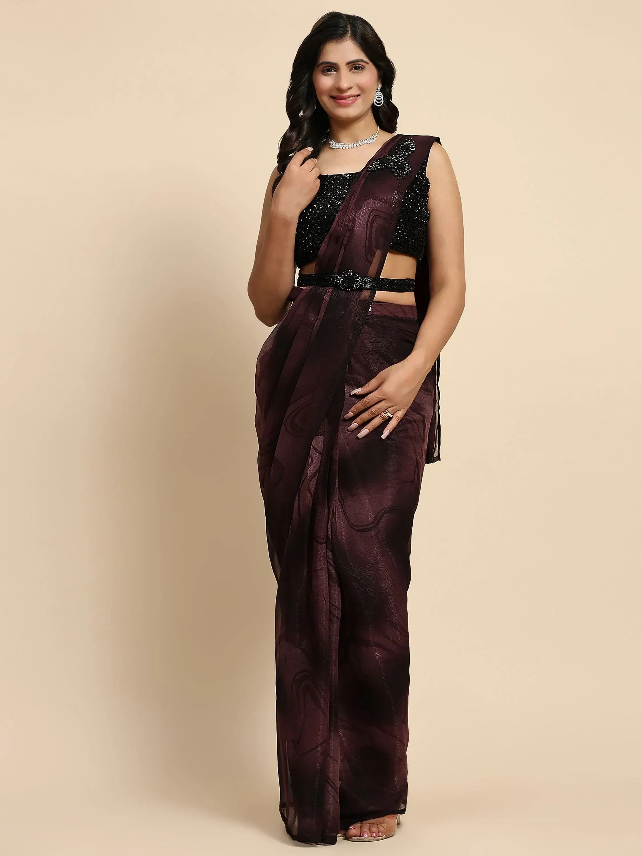 Woman in elegant maroon saree with black sequin blouse, perfect for Indian ethnic occasions