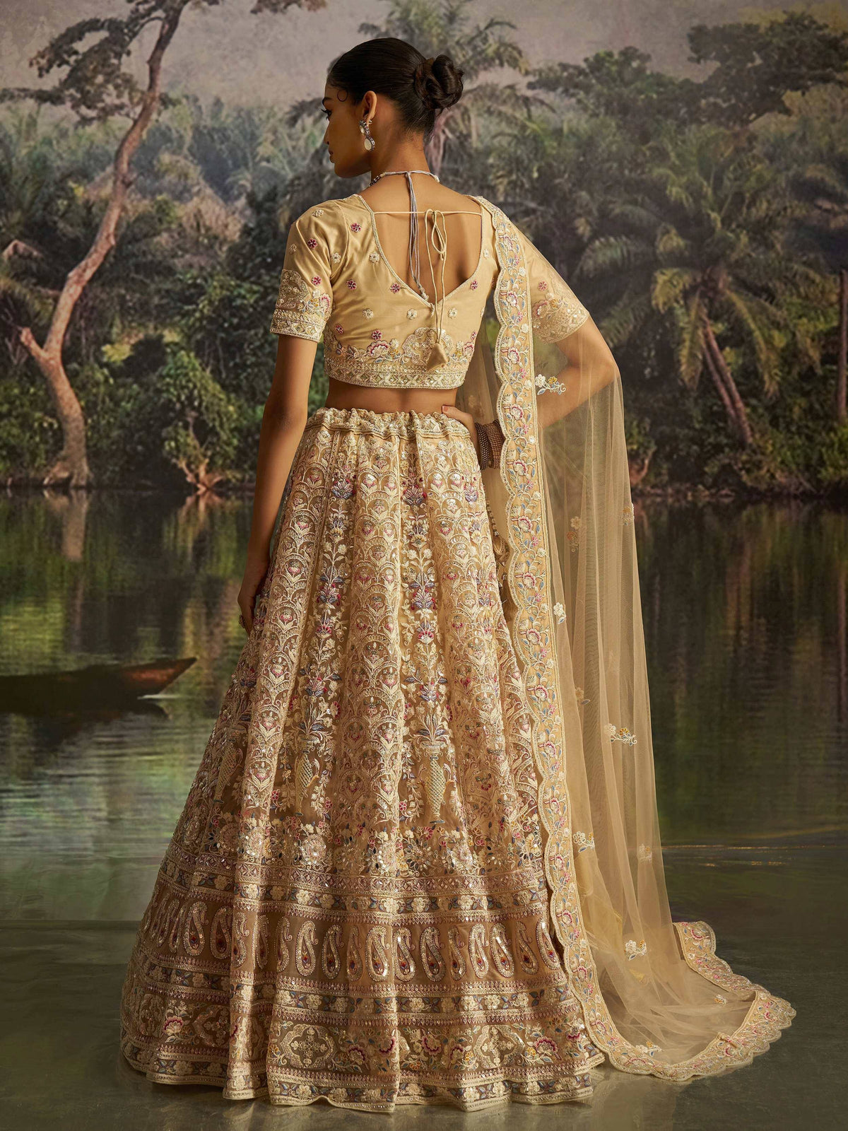 Elegant gold embroidered lehenga choli with floral motifs, perfect for Indian weddings and festive occasions.