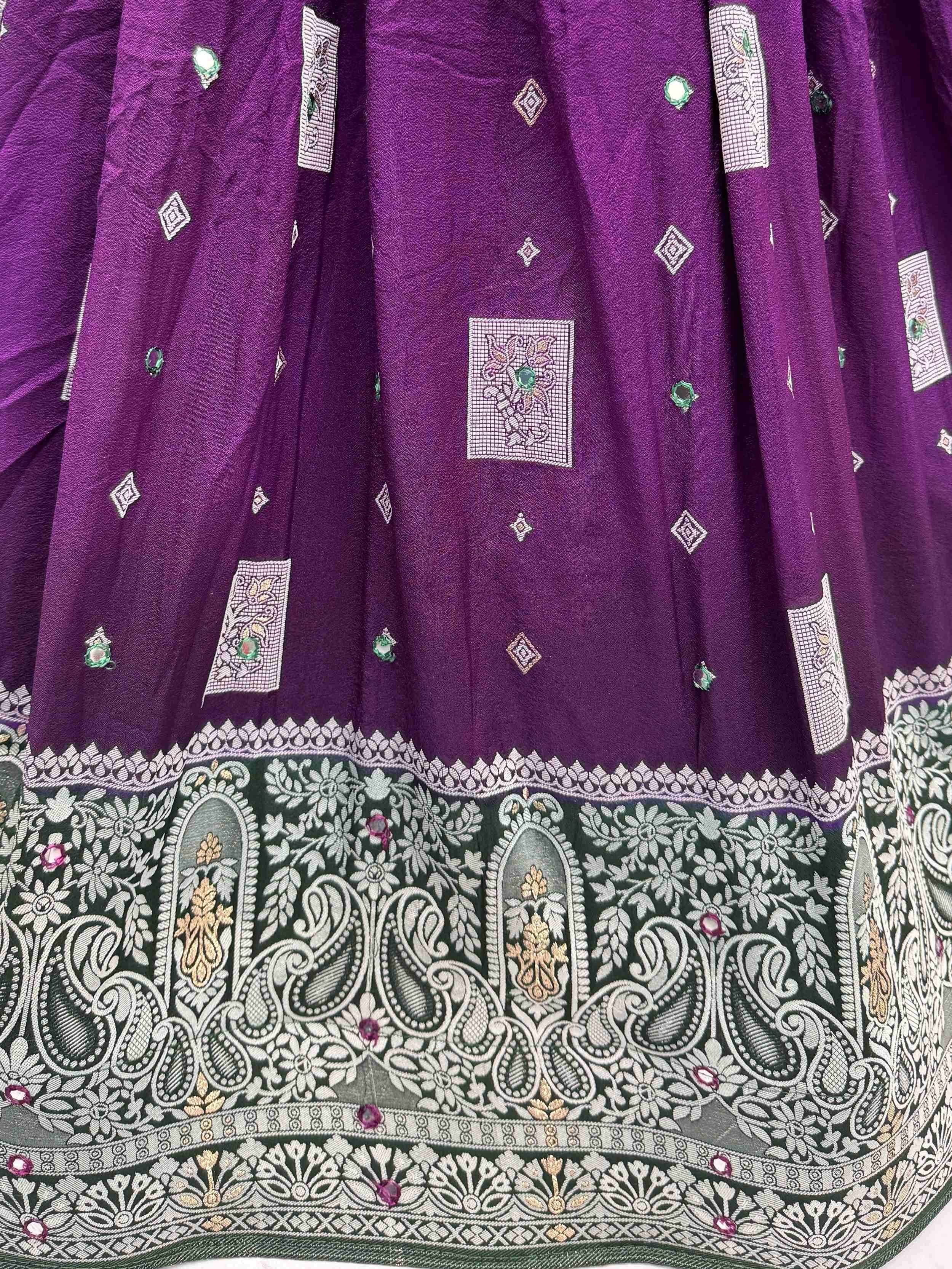 Purple designer lehenga with intricate embroidery, mirror work, and detailed border for Indian ethnic wear