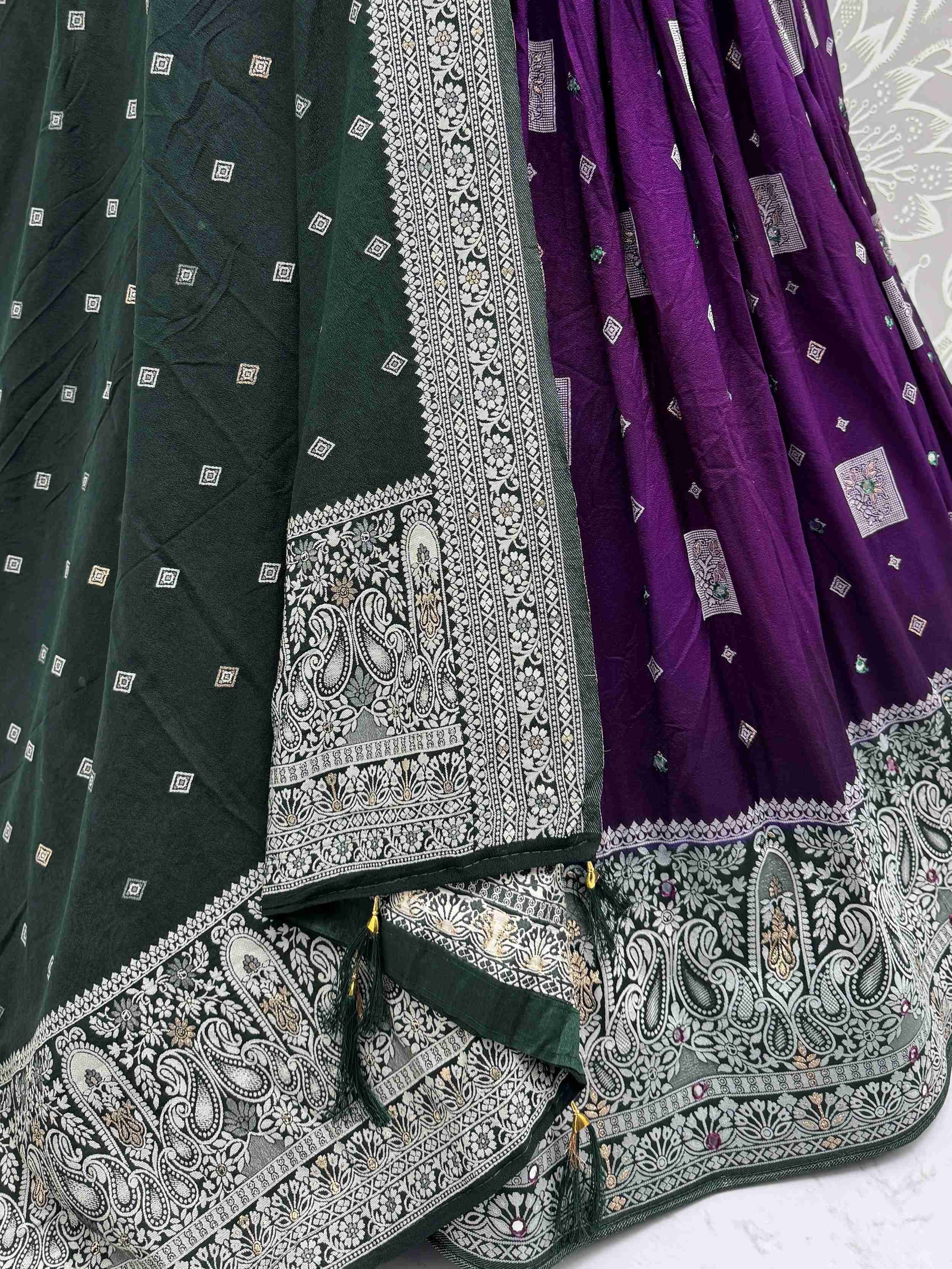 Green and purple ethnic lehenga with intricate paisley embroidery and mirror work, perfect for Indian weddings.