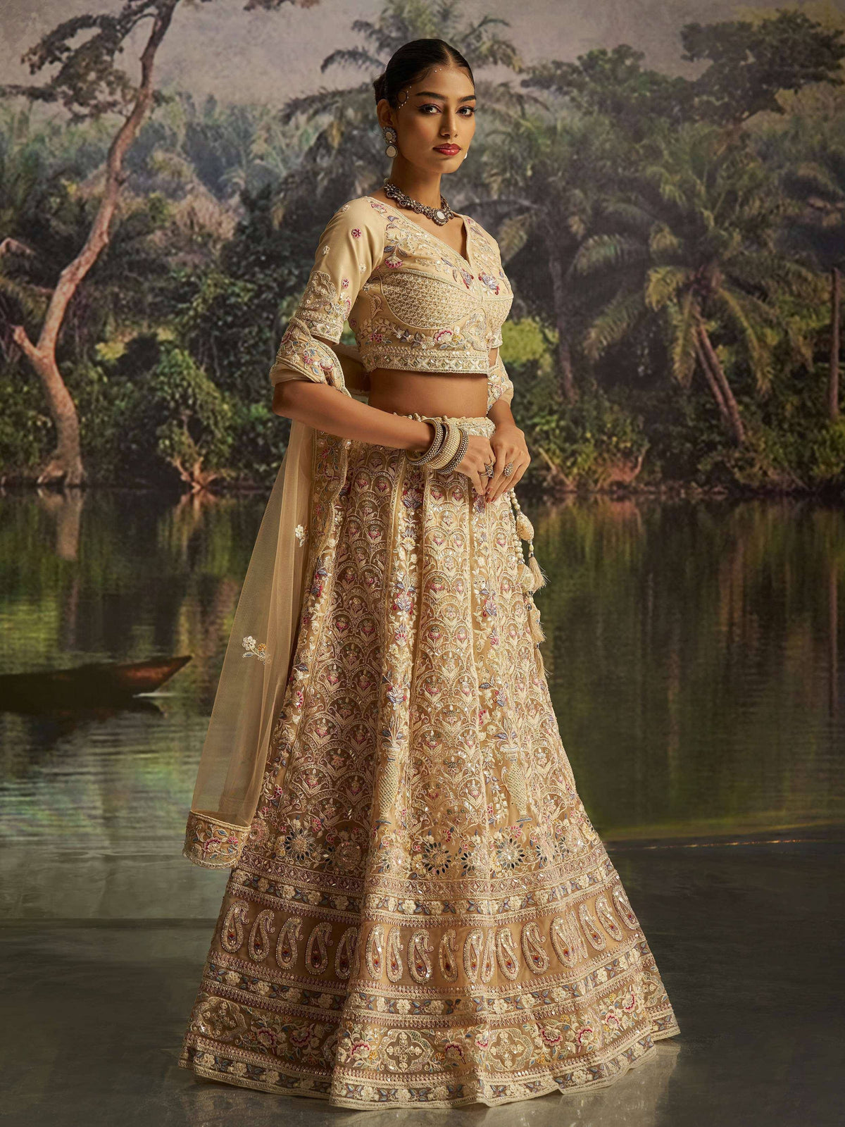 Elegant beige embroidered lehenga choli with floral motifs, perfect for Indian weddings and festive occasions.