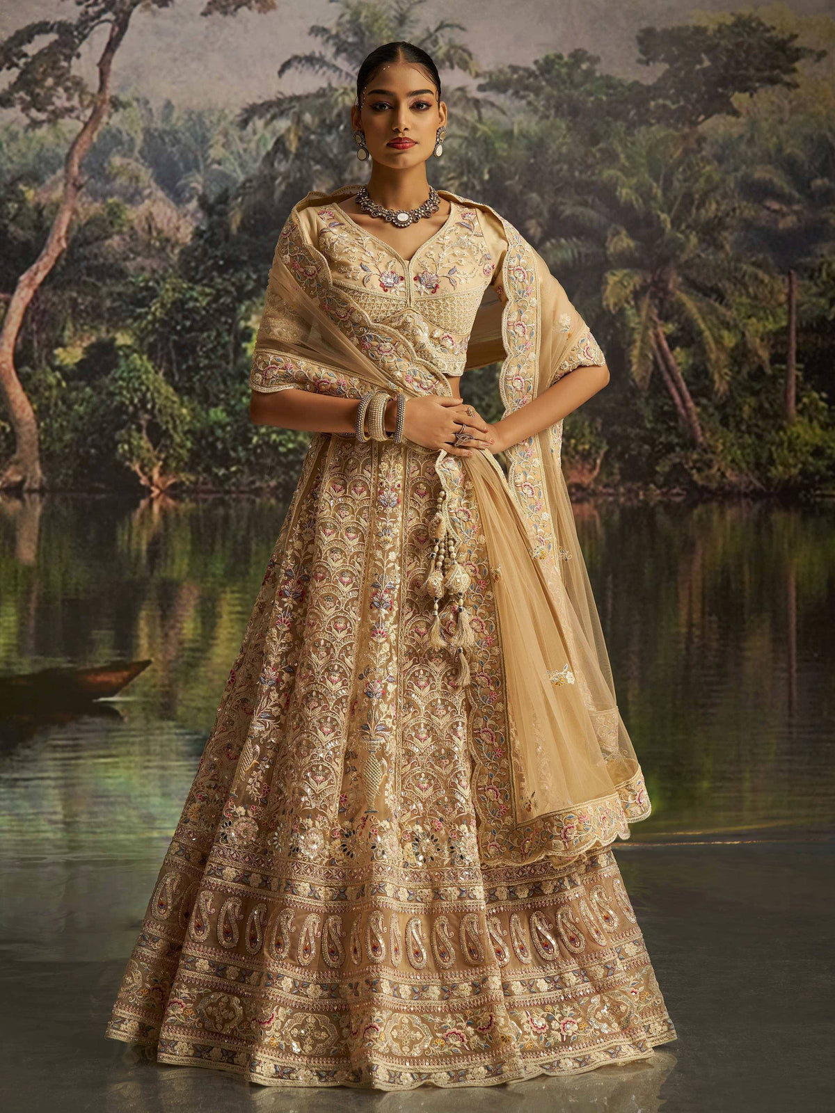 Elegant beige embroidered lehenga choli with floral motifs, perfect for Indian weddings and festive occasions.