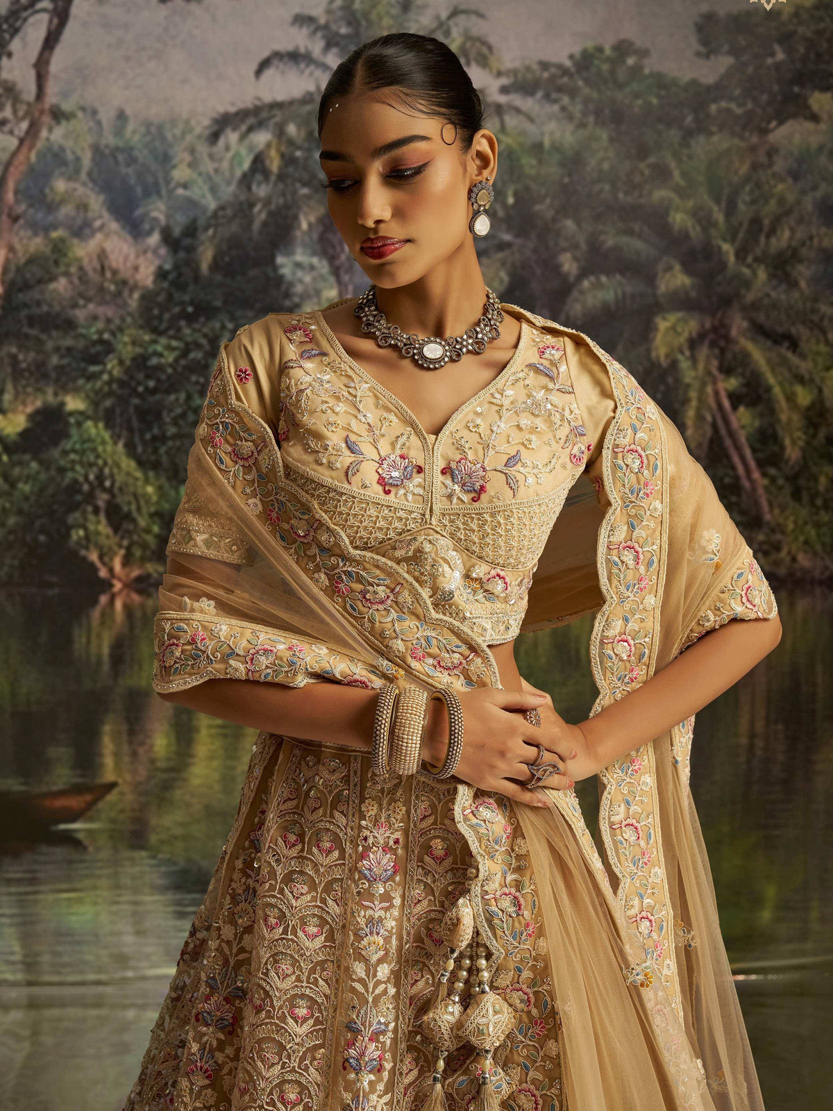 Elegant gold embroidered lehenga choli with floral detailing, perfect for Indian ethnic wear occasions.
