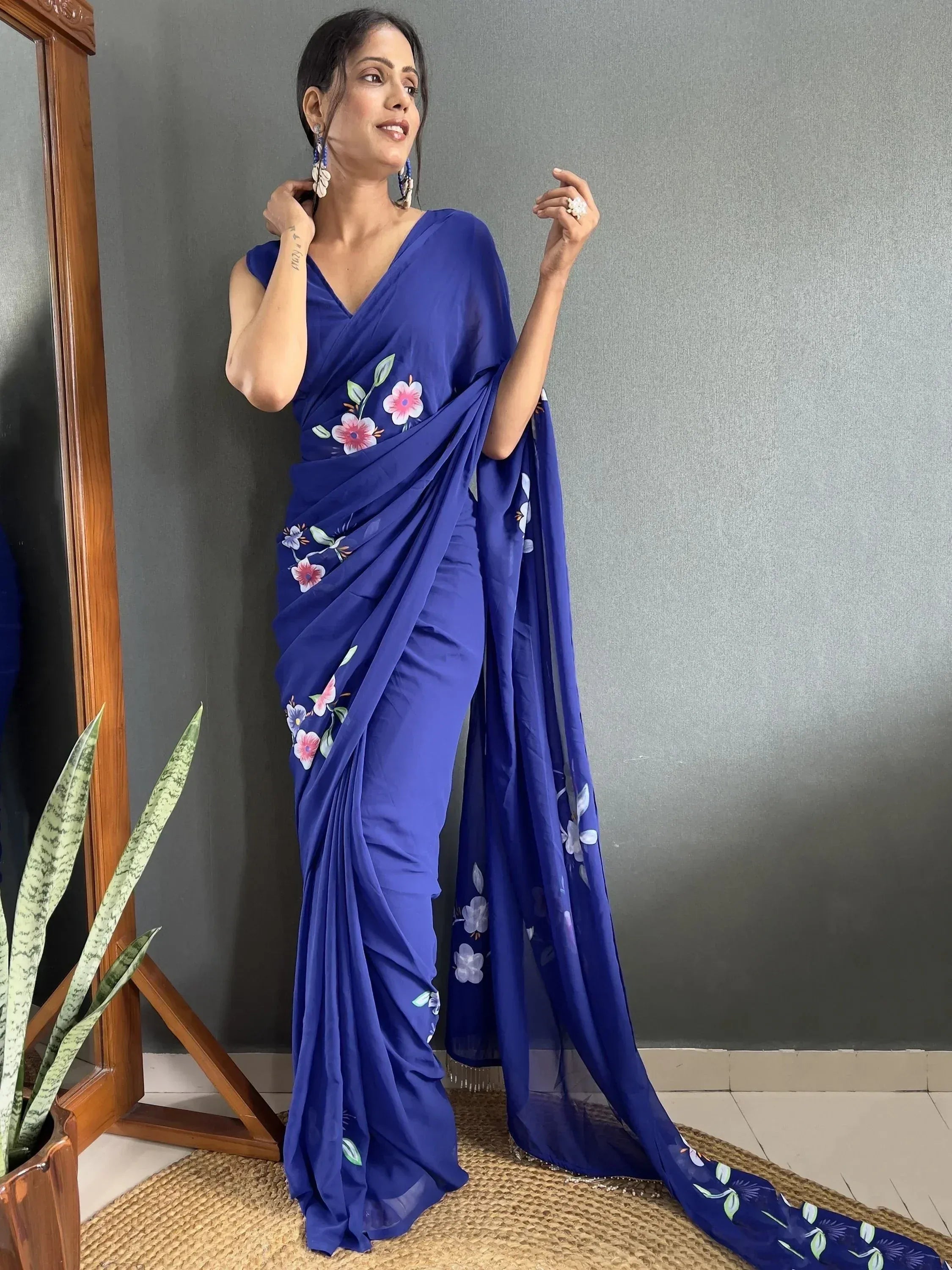 Woman in royal blue floral print saree, Indian ethnic wear with elegant drape and designer blouse