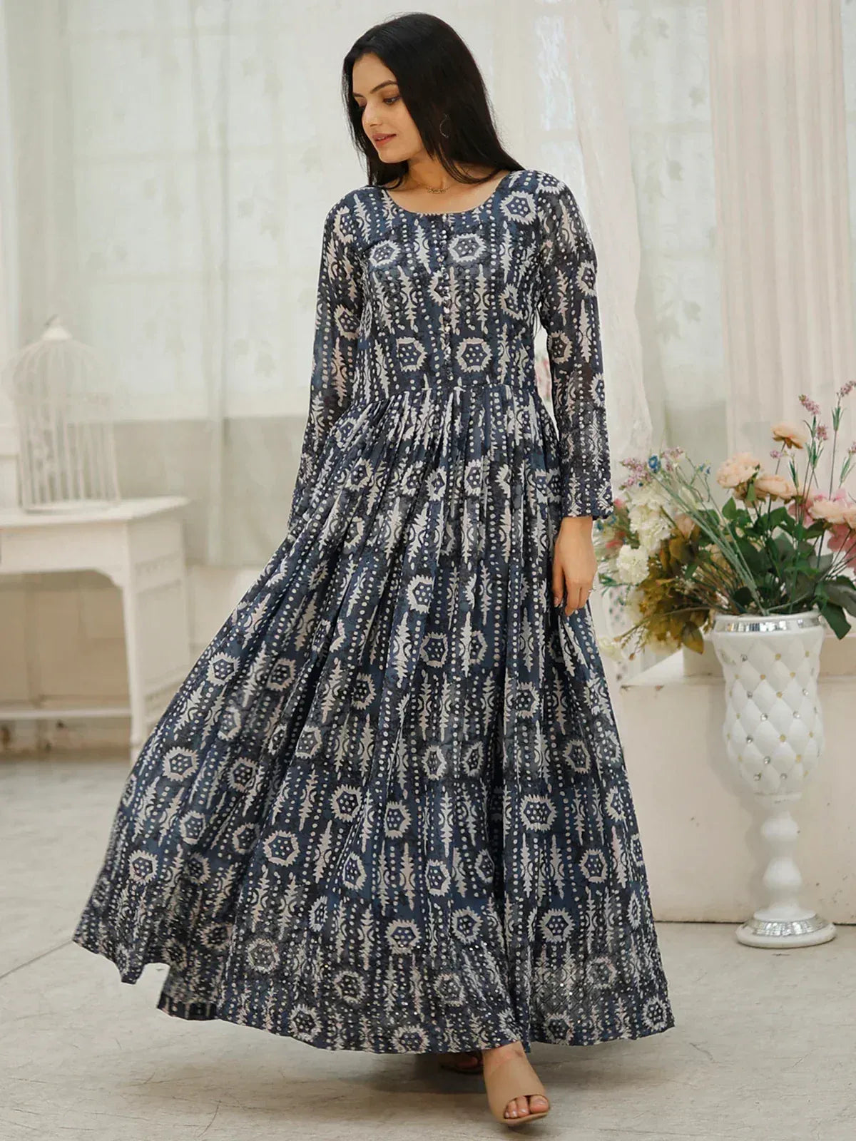 Woman in navy blue and white printed ethnic gown with long sleeves, ideal for Indian occasions