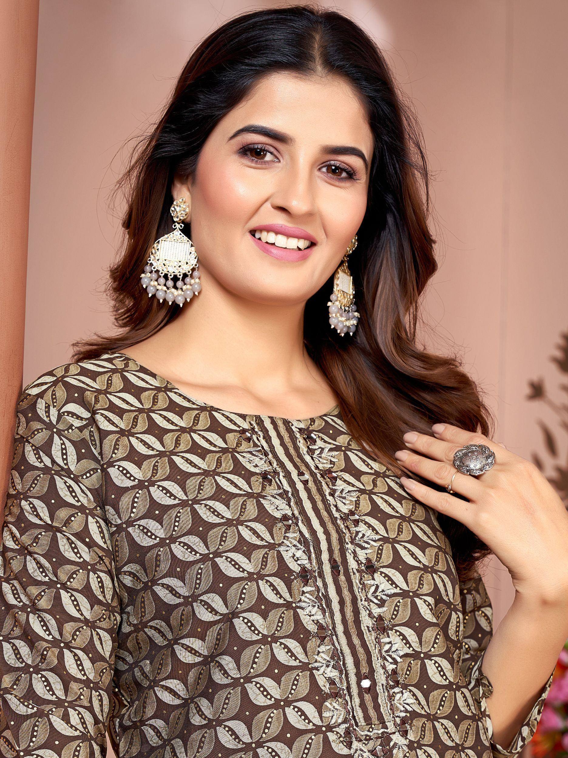 Woman in elegant brown printed ethnic kurta with gold embroidery, paired with statement jhumka earrings for festive occasions.