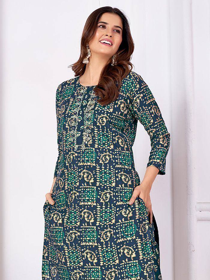 Woman in green and navy printed ethnic gown with pocket details, perfect for Indian occasions
