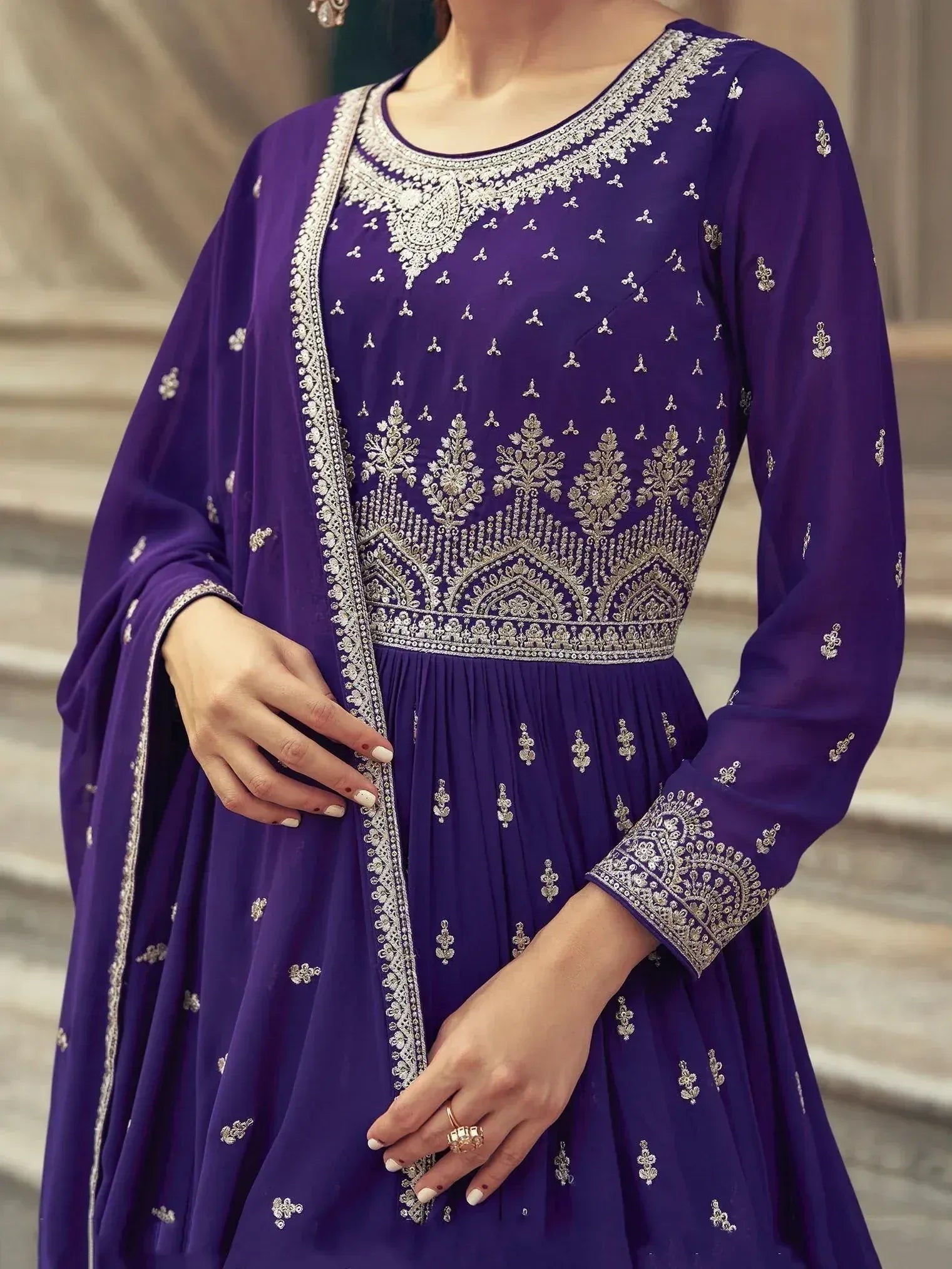 Purple embroidered ethnic gown with intricate silver detailing and pleated design