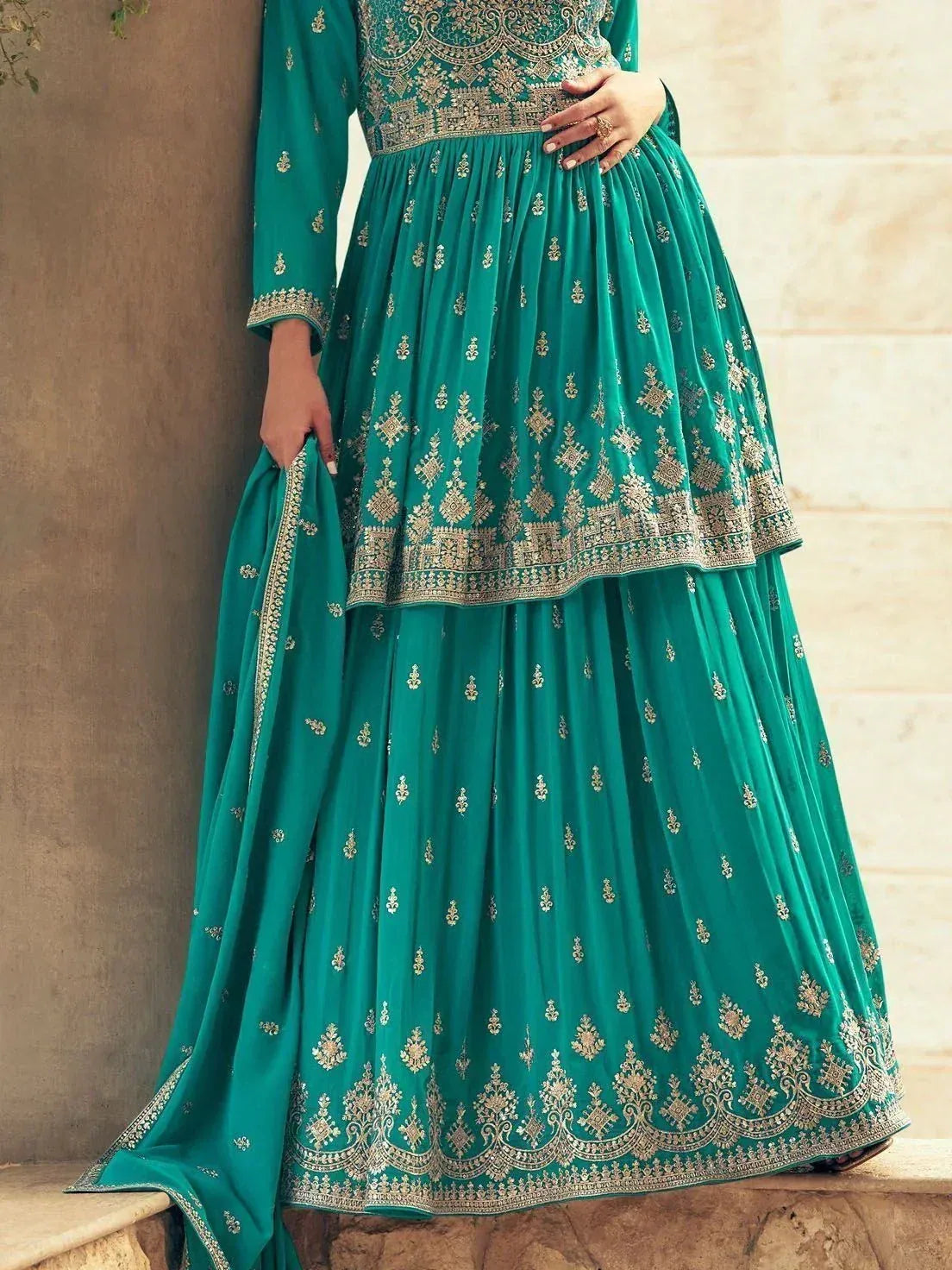 Emerald green embroidered anarkali suit with gold detailing, perfect for Indian ethnic occasions.