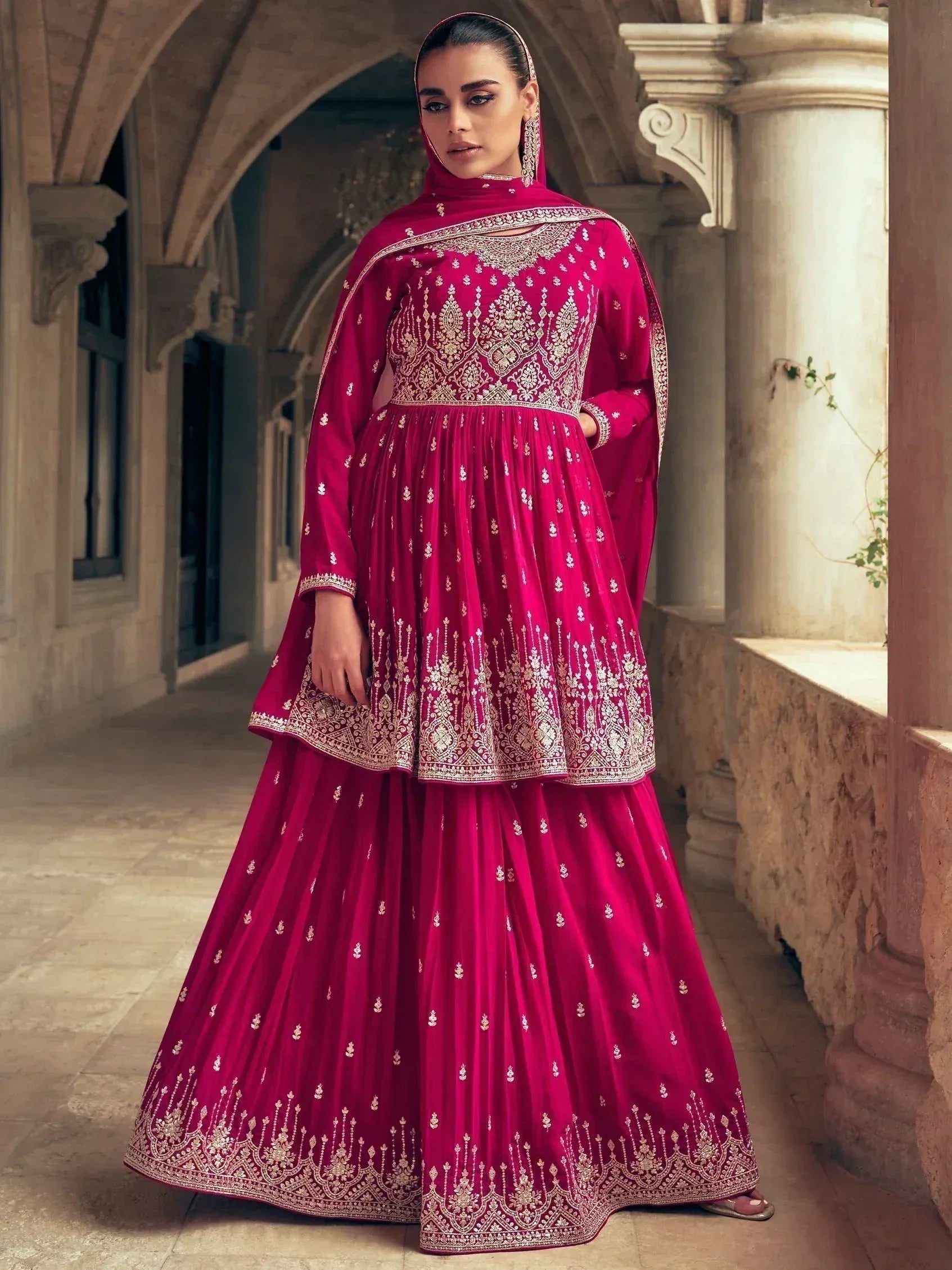 Elegant maroon ethnic anarkali suit with gold embroidery, perfect for Indian weddings and festive occasions.