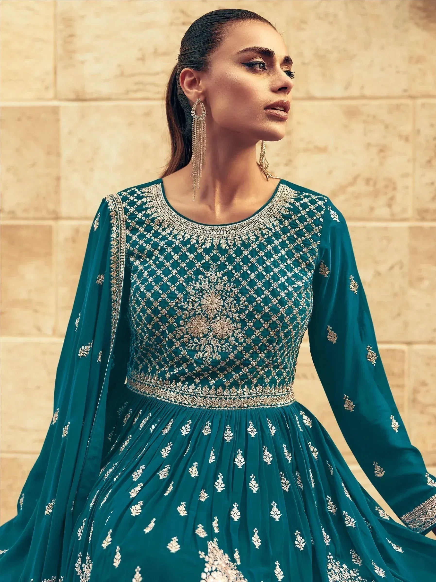 Teal embroidered anarkali gown with gold detailing, perfect for Indian ethnic wear occasions.