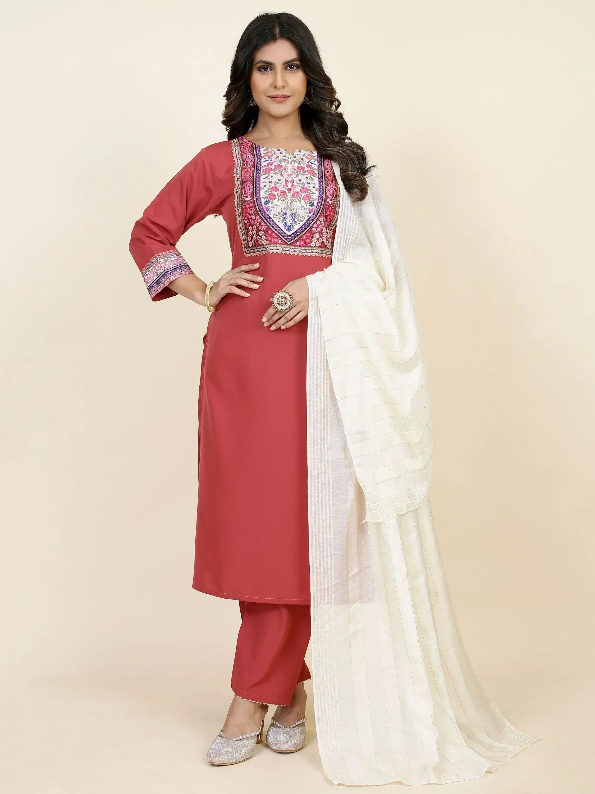 Woman wearing pink embroidered salwar kameez with white dupatta, ethnic Indian outfit