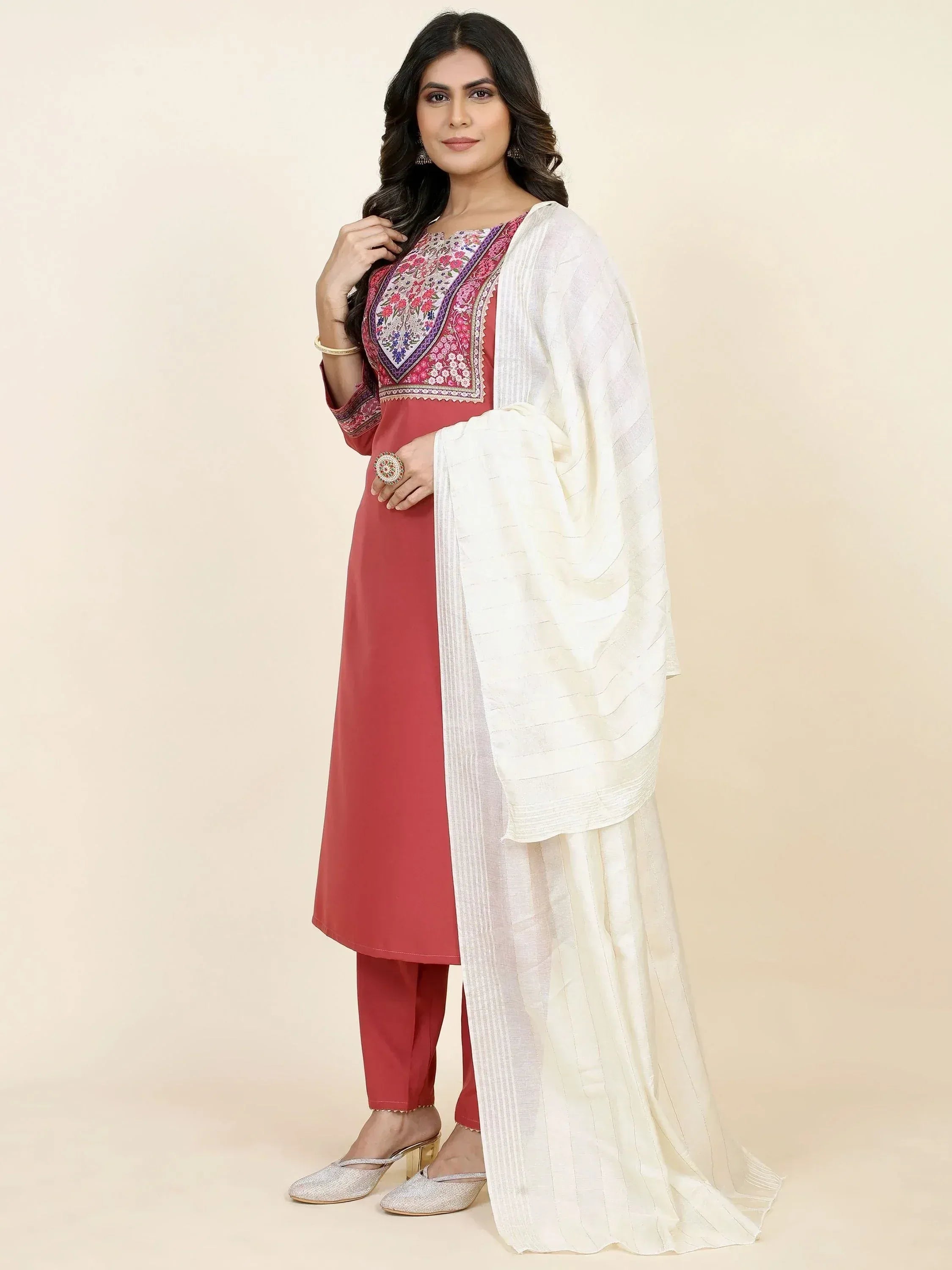 Woman wearing a red embroidered straight cut salwar kameez with white dupatta