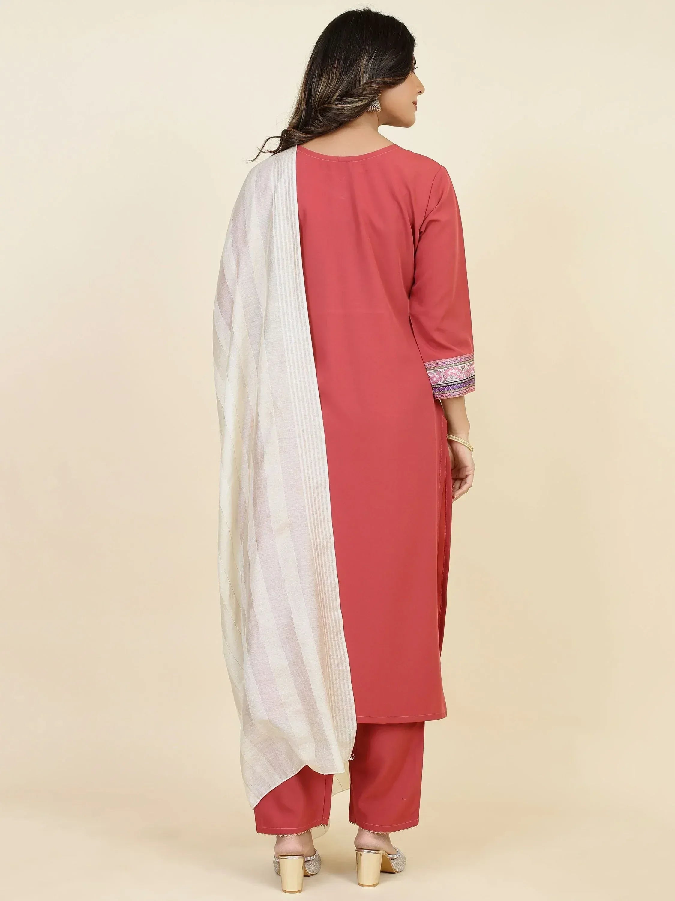 Woman in pink kurta and pants set with white dupatta, ethnic wear, back view