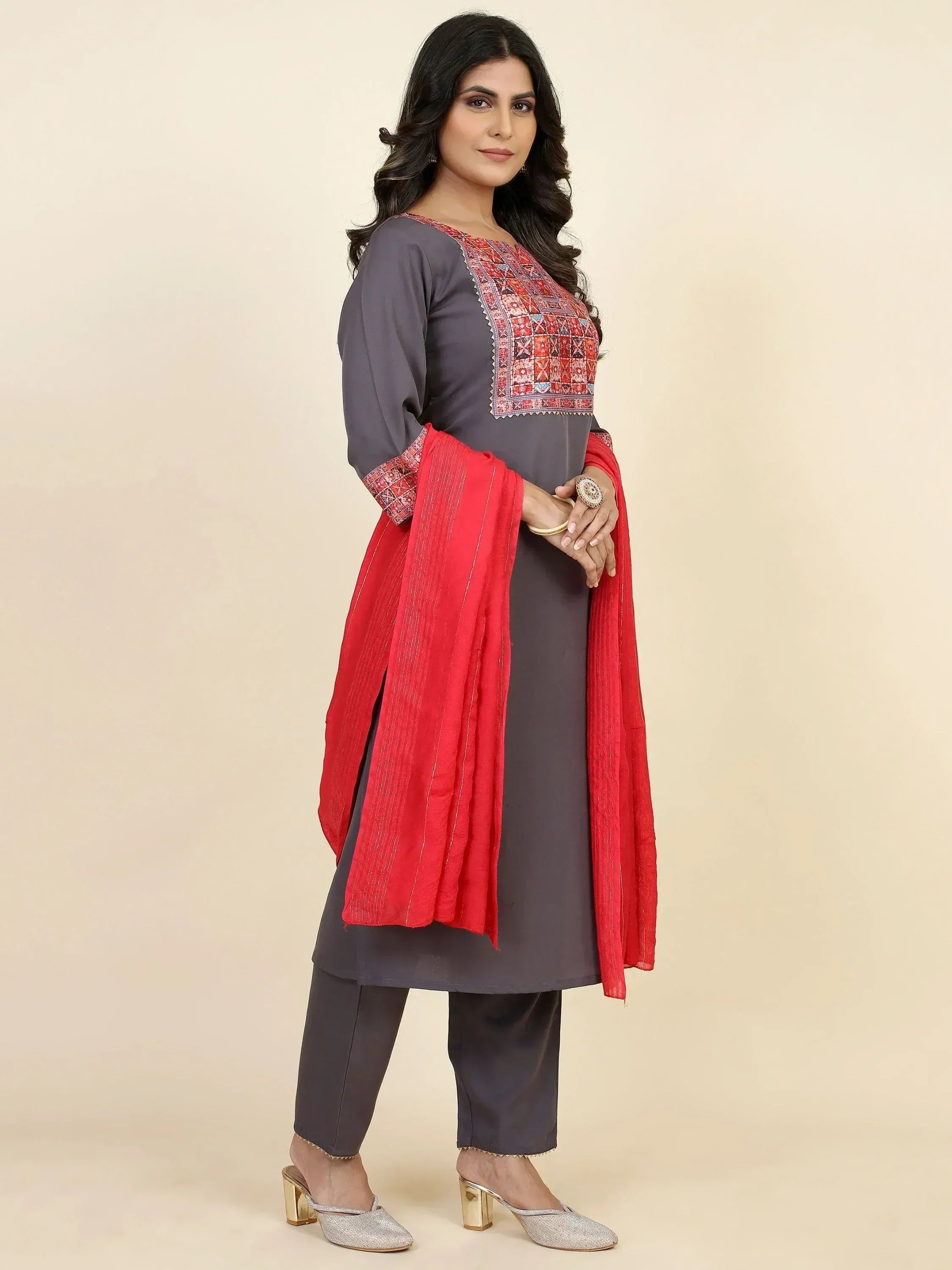Grey embroidered kurta with red dupatta, paired with matching pants and silver heels for ethnic wear