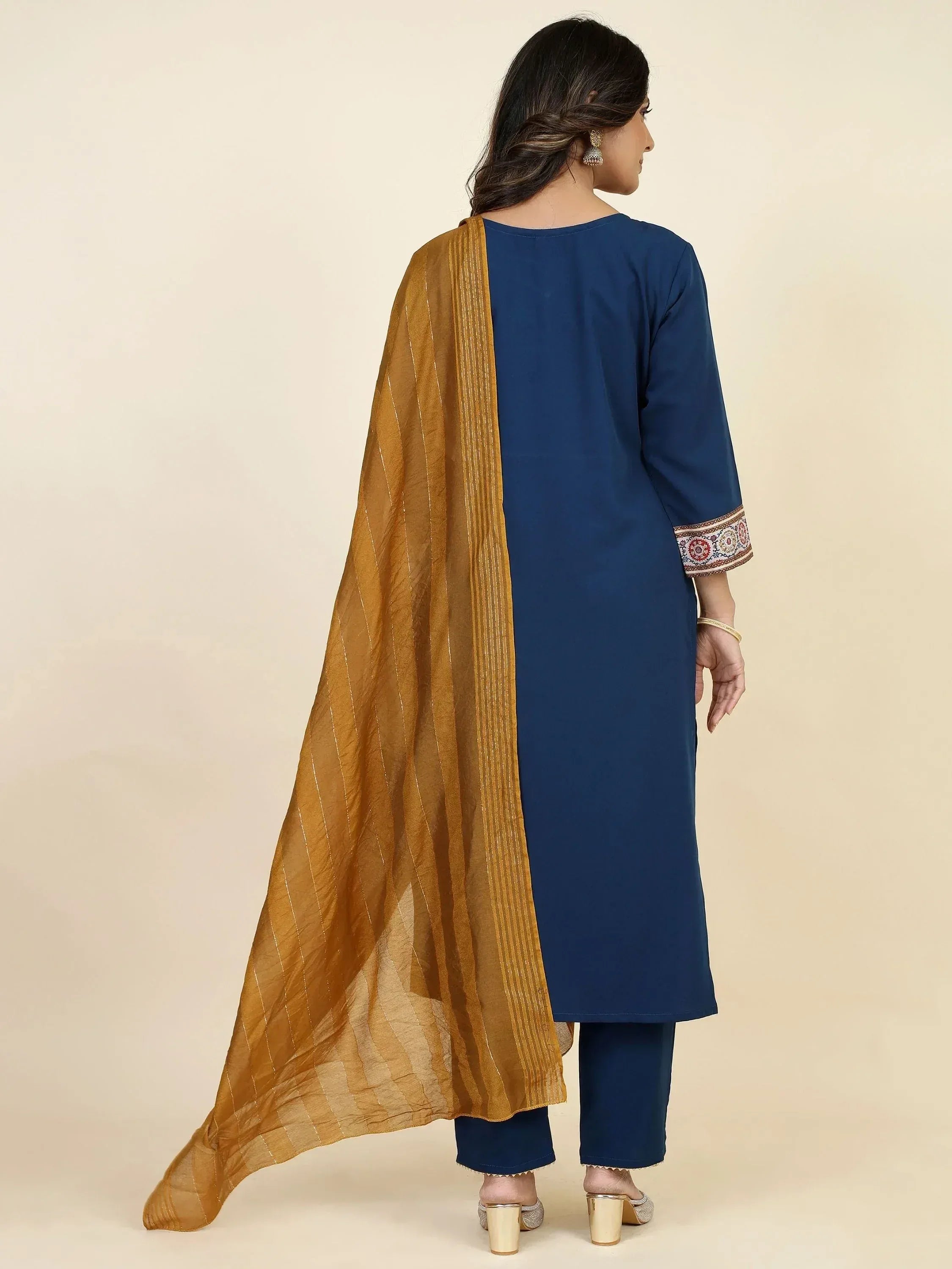 Navy blue kurta with embroidered sleeves paired with matching pants and mustard dupatta, ideal for ethnic wear.