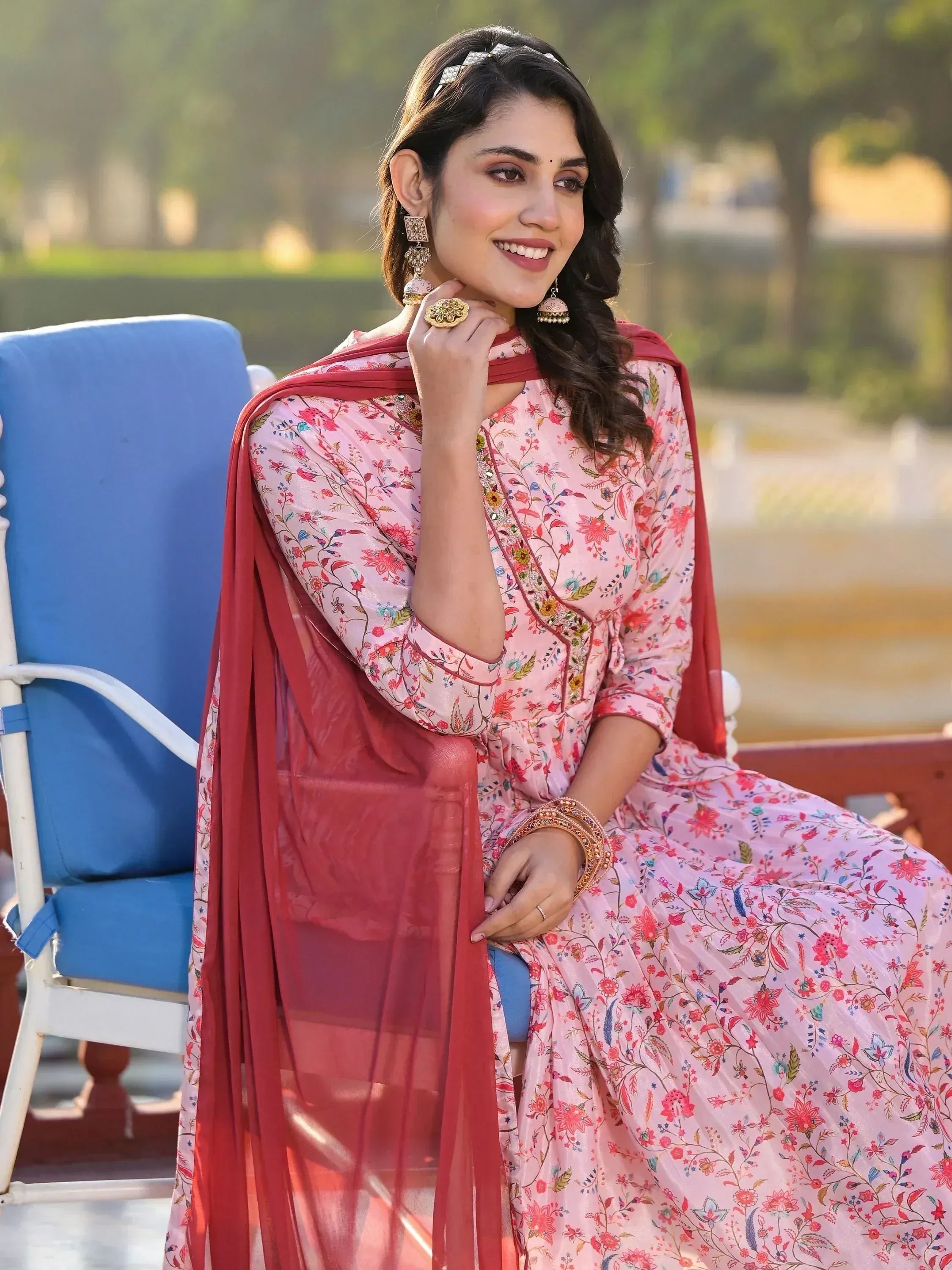 Woman in pink floral ethnic gown with red dupatta, traditional Indian wear for festive occasions