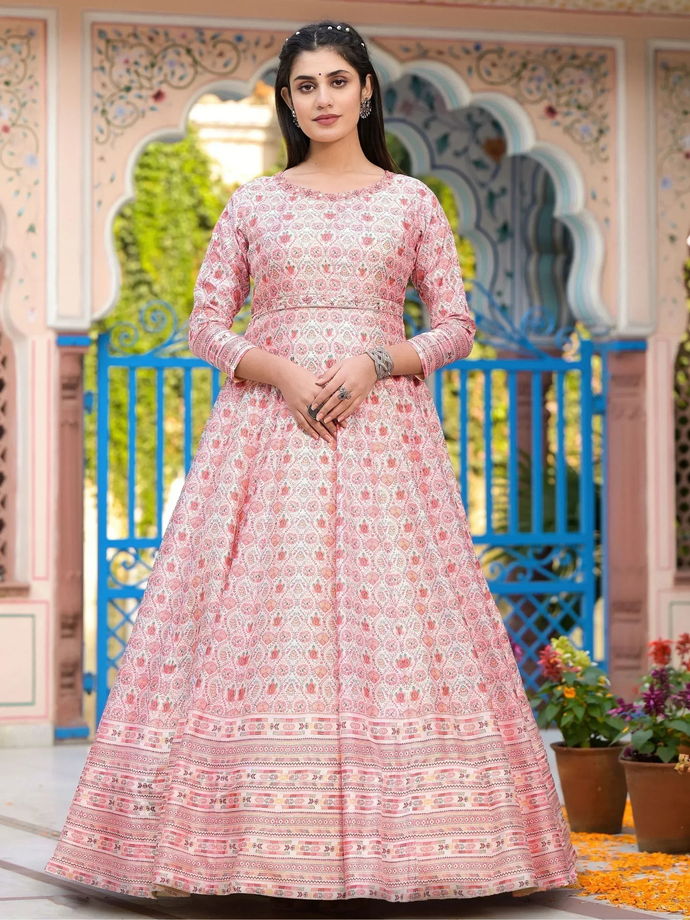 Pink floral printed ethnic gown with intricate border, perfect for Indian occasions and festive wear.