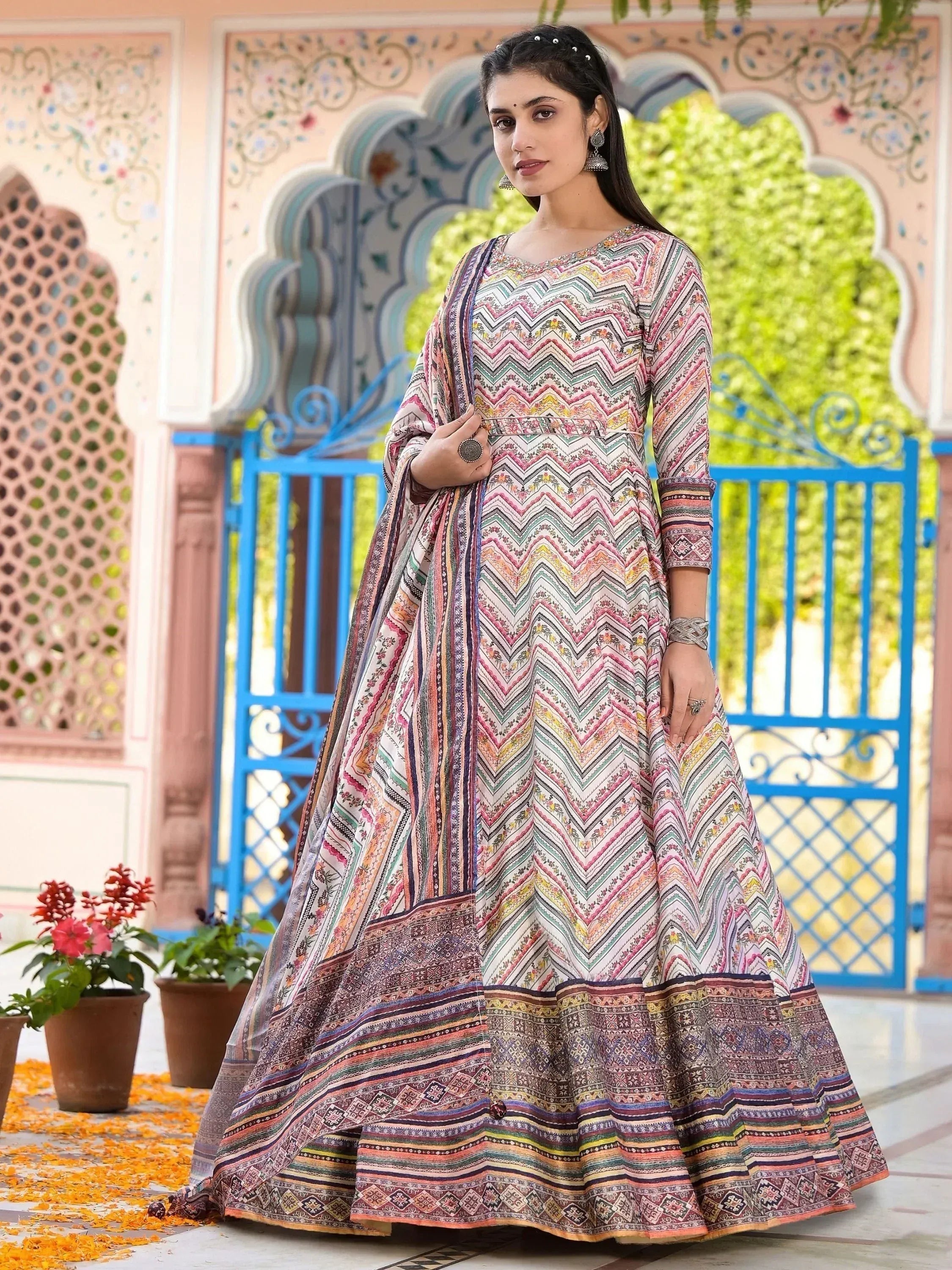 Woman in colorful printed ethnic anarkali gown with chevron patterns, perfect for Indian occasions