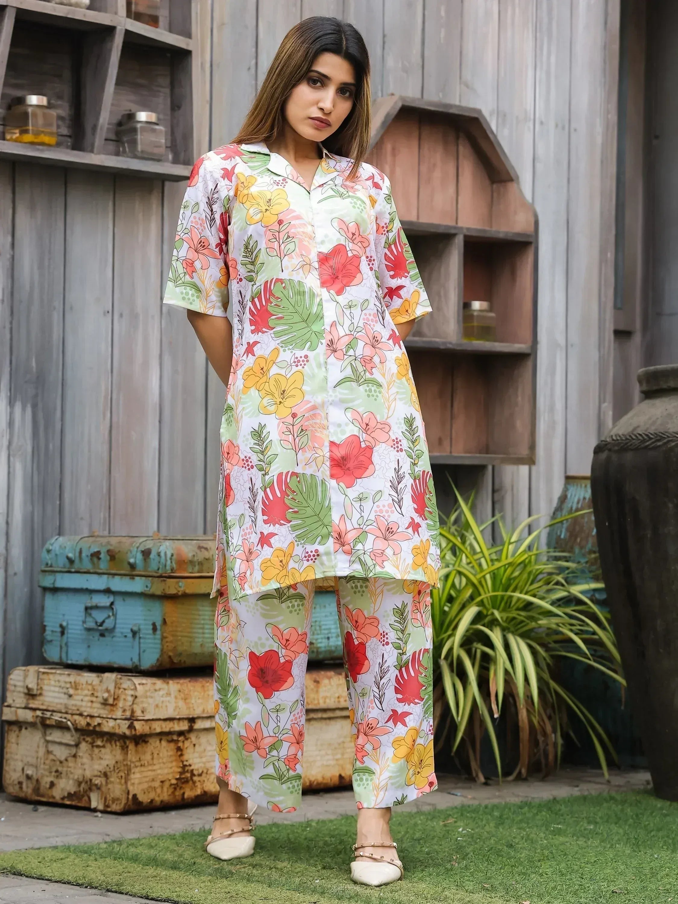 Floral print ethnic kurta set with matching pants, vibrant flowers and green leaves on white background