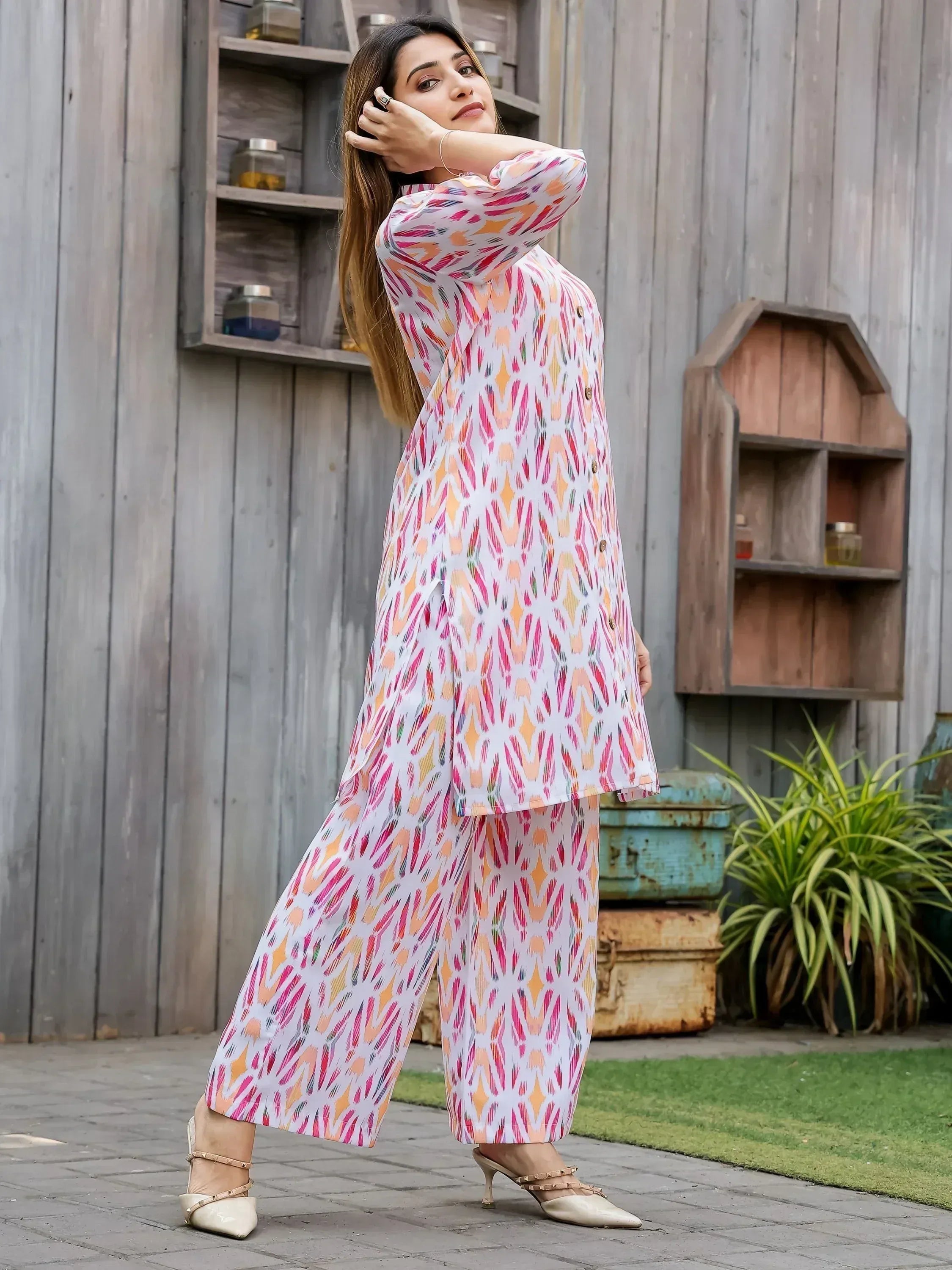 Woman in colorful printed ethnic kurta set with wide pants, perfect for casual Indian wear