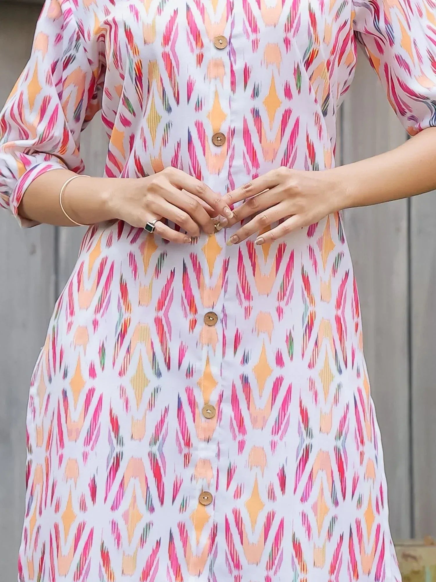 Colorful ikat print ethnic gown with button front and puff sleeves, perfect for casual wear.