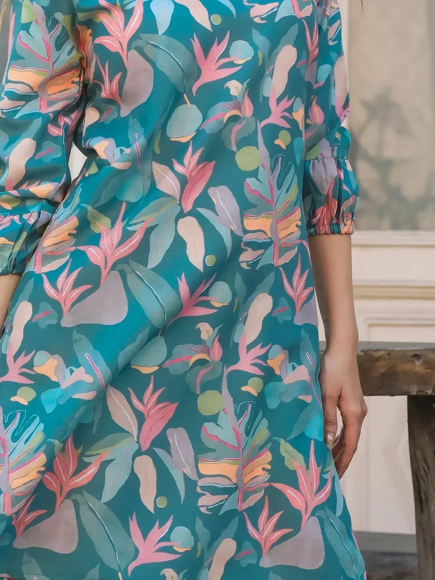 Teal ethnic gown with vibrant tropical leaf print, ruffled sleeves, perfect for Indian festive occasions