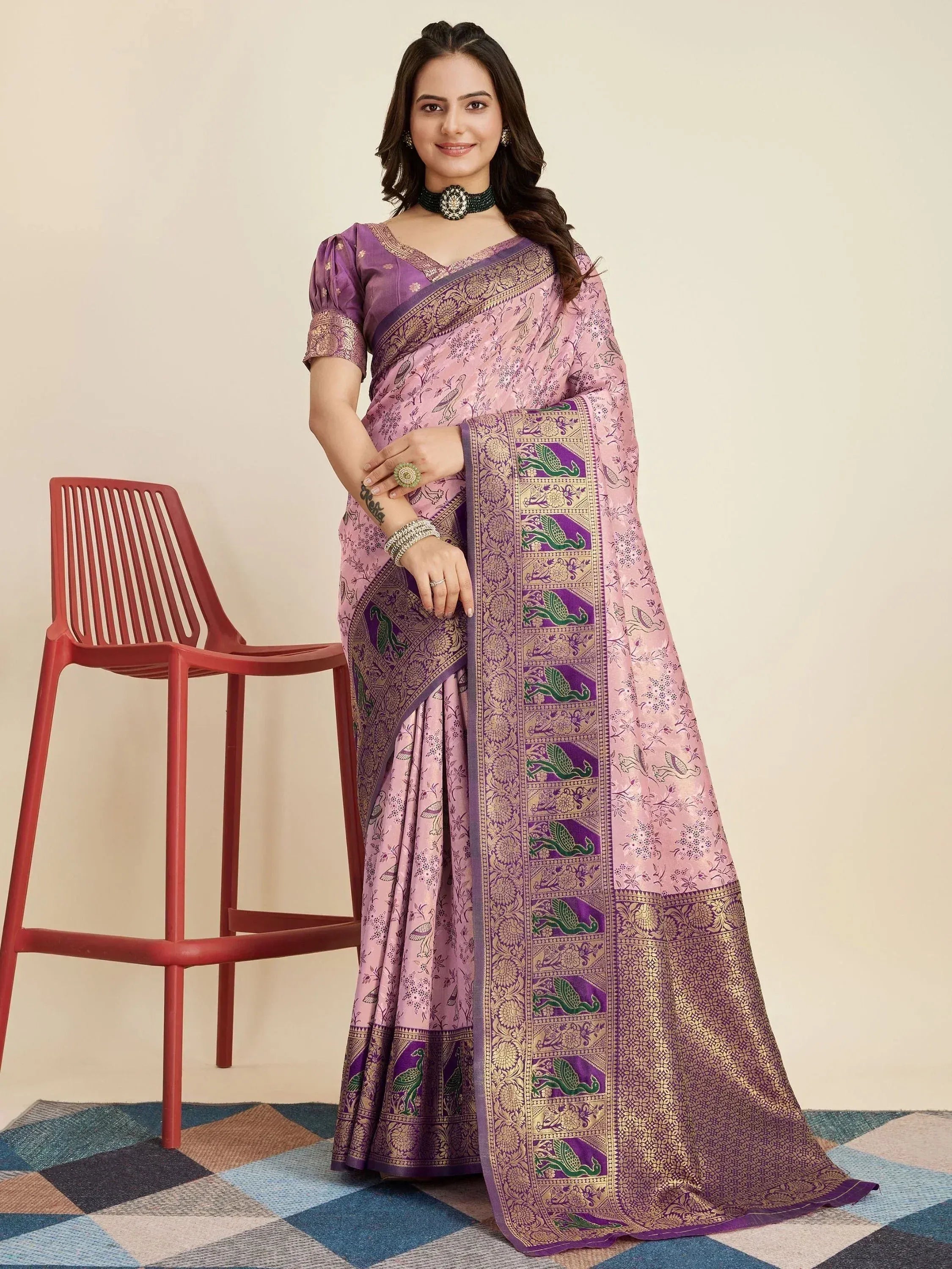 Purple and pink designer saree with peacock motifs and gold border, paired with matching blouse for ethnic wear