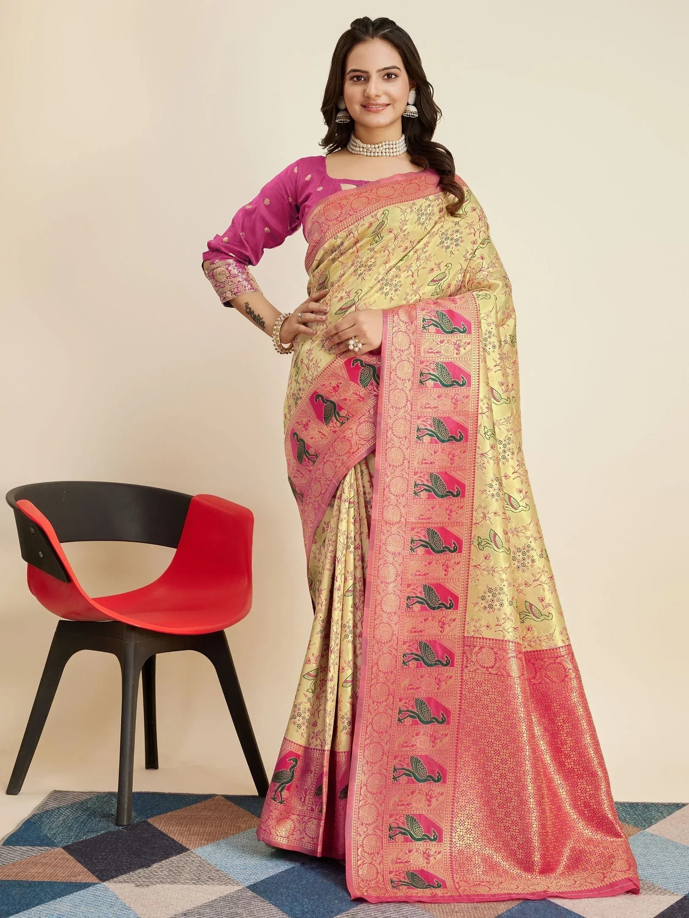 Elegant Indian saree with peacock motifs, pink border, and golden fabric, paired with a purple blouse.