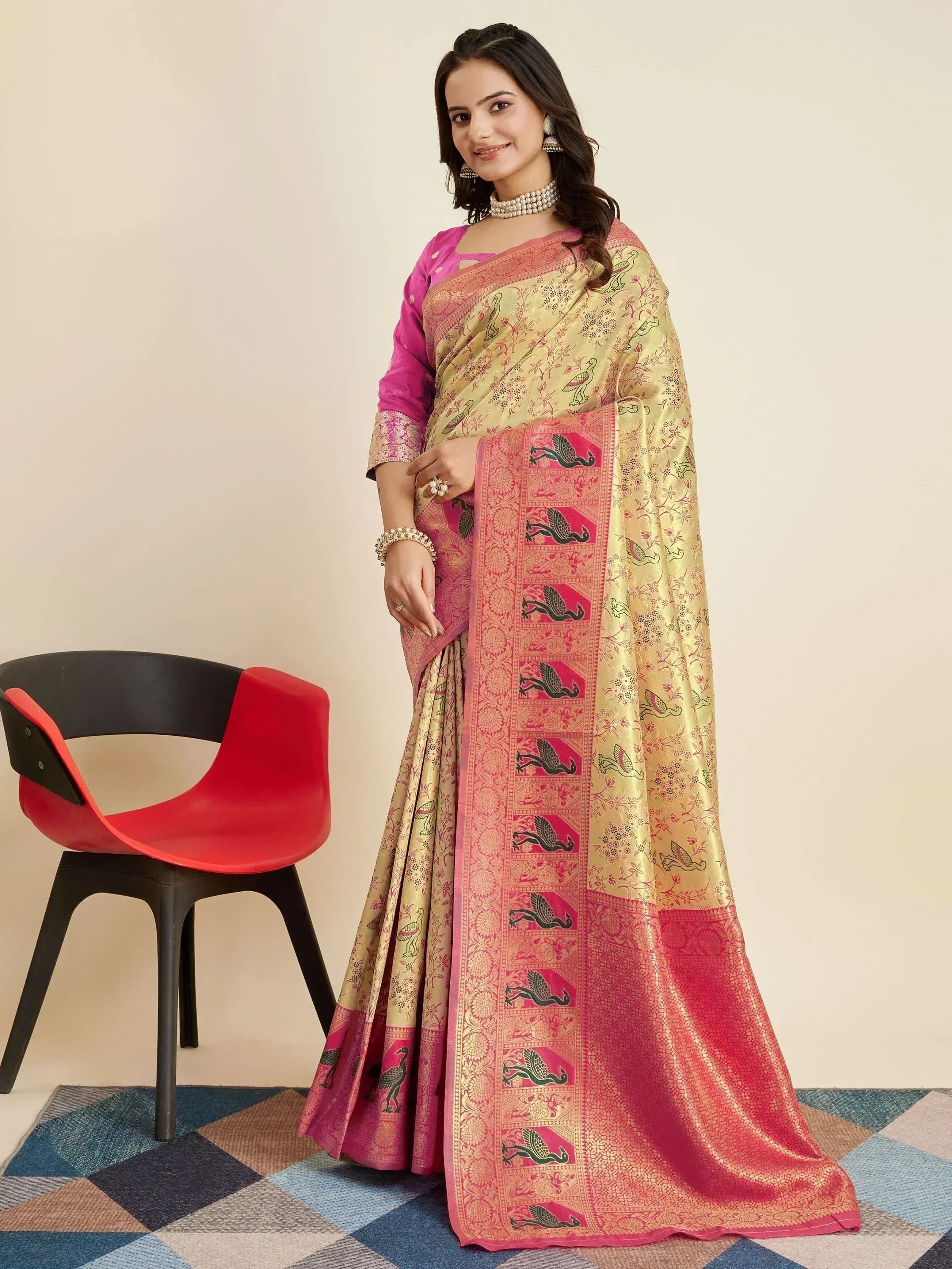 Elegant Indian saree with pink and gold bird motifs, paired with a matching blouse for festive occasions.