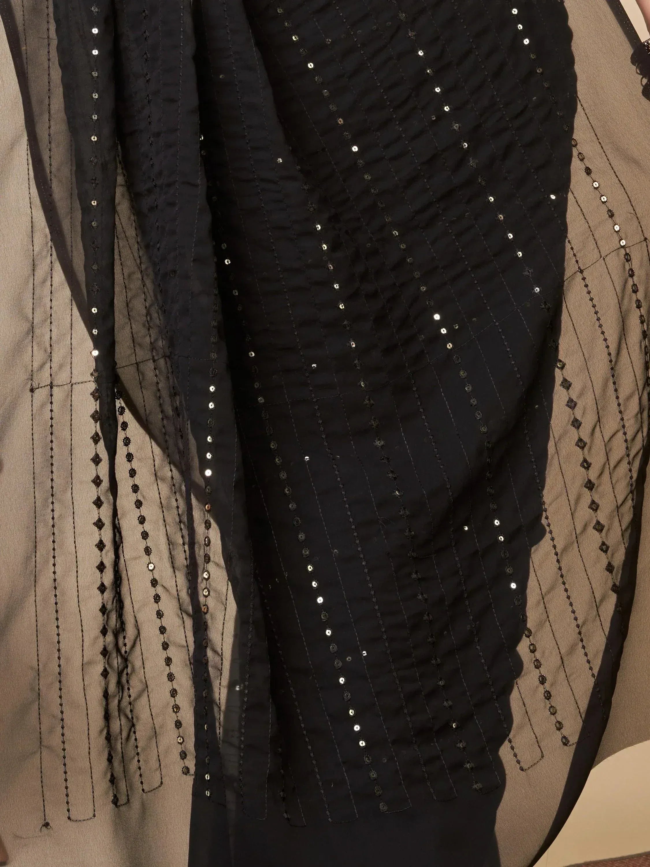 Black sequin-embellished ethnic gown with sheer overlay and intricate beadwork details