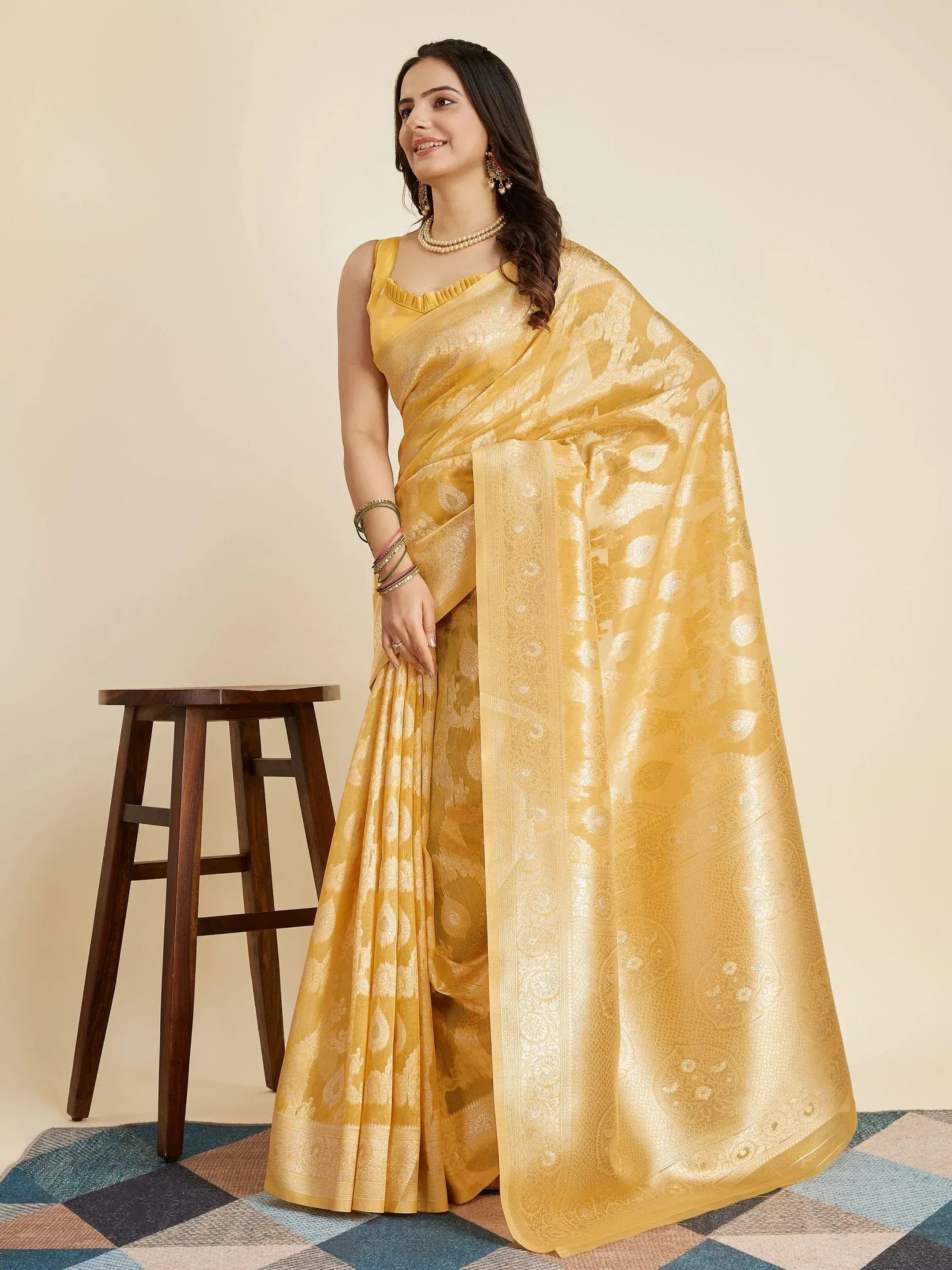 Yellow designer saree with intricate gold patterns, perfect for ethnic occasions