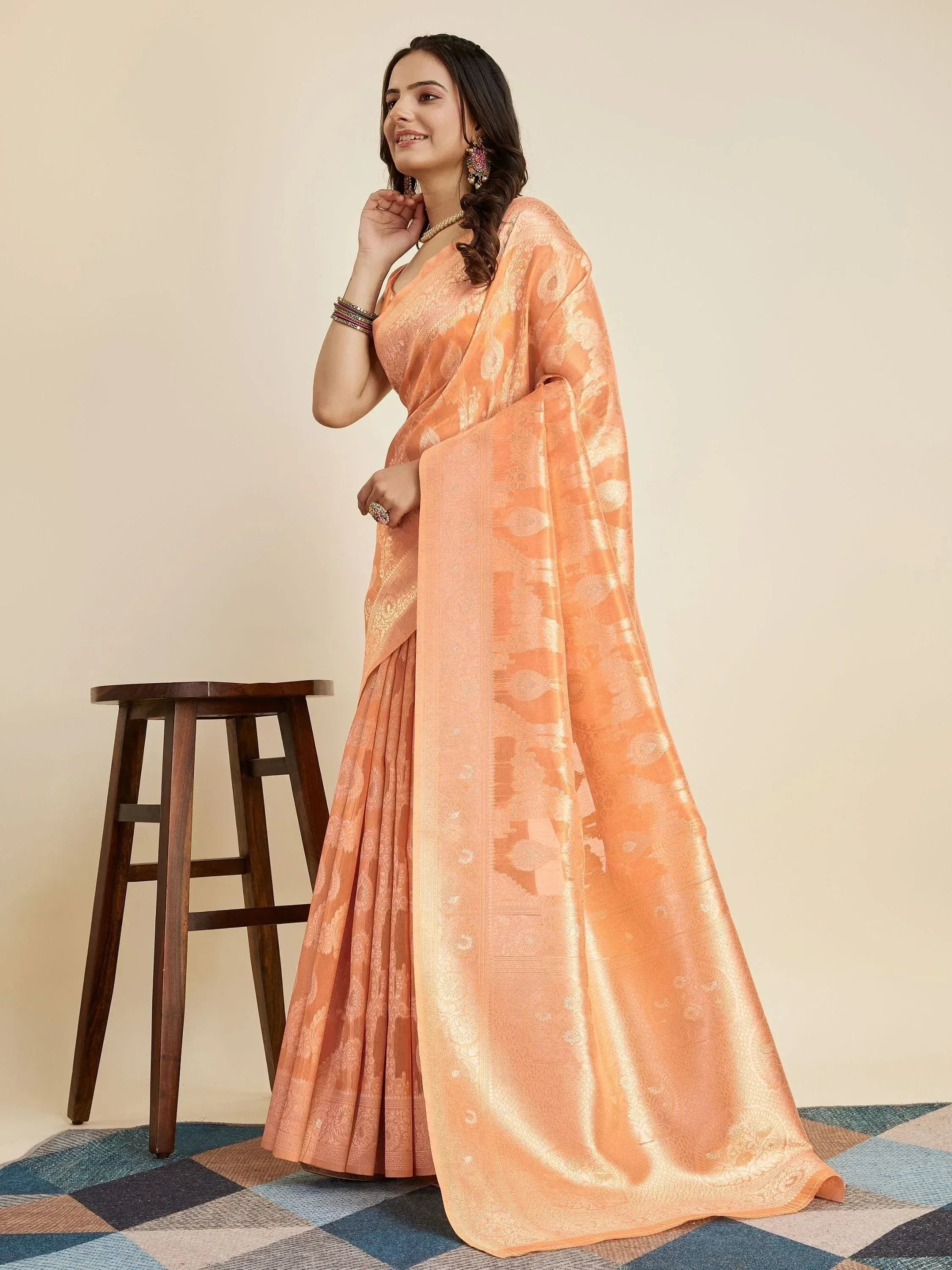 Peach designer saree with gold floral weave, perfect for Indian ethnic wear occasions