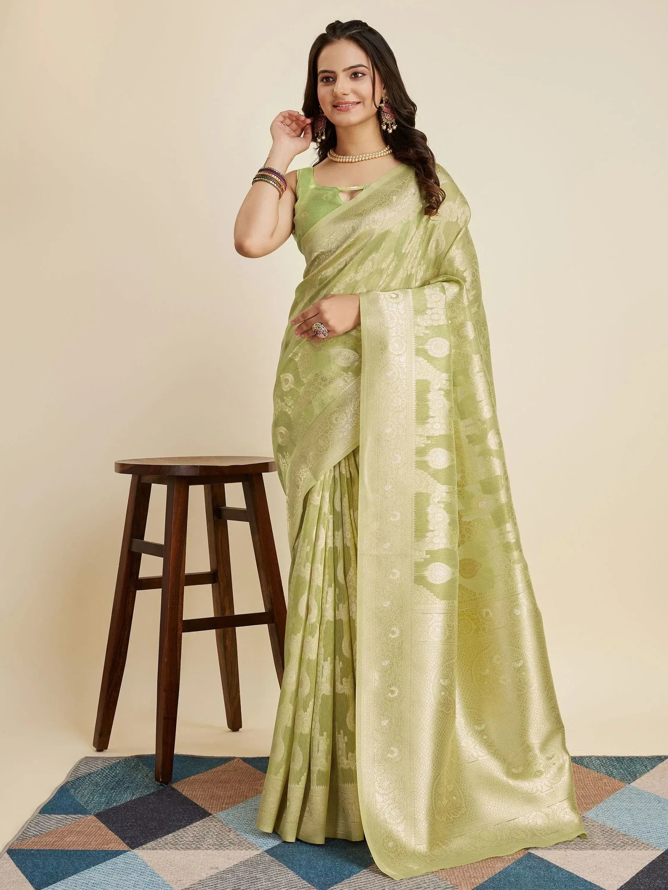 Light green designer saree with gold zari work, perfect for ethnic occasions