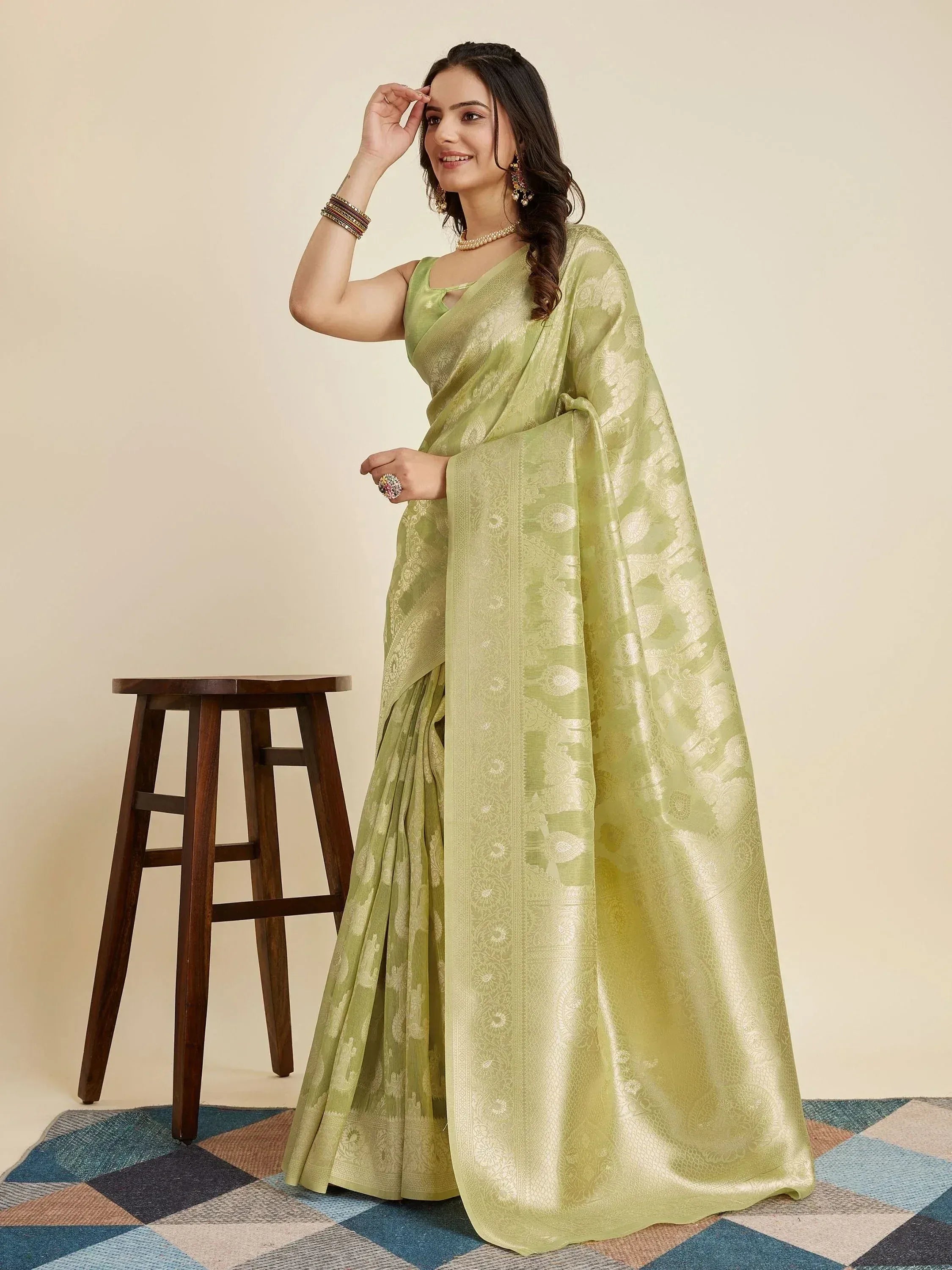 Light green designer saree with gold floral weave, perfect for ethnic occasions and Indian festivals