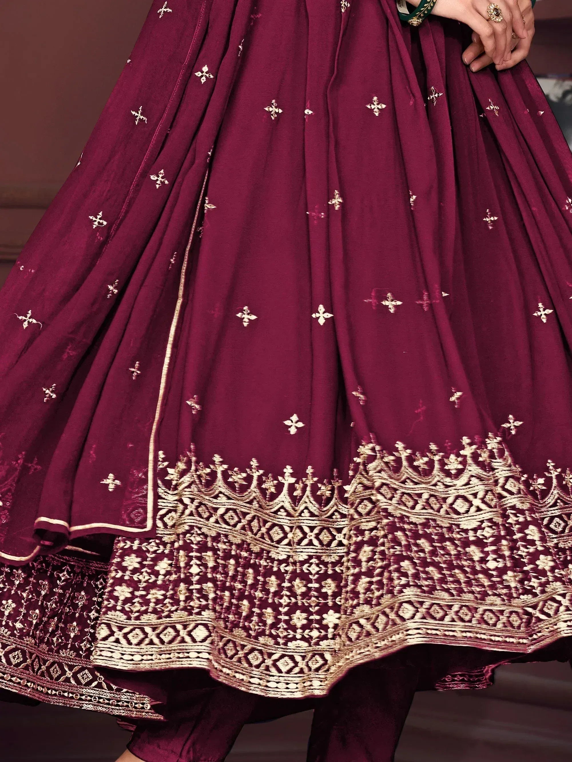 Burgundy lehenga with gold embroidery and floral motifs, perfect for Indian ethnic wear occasions.