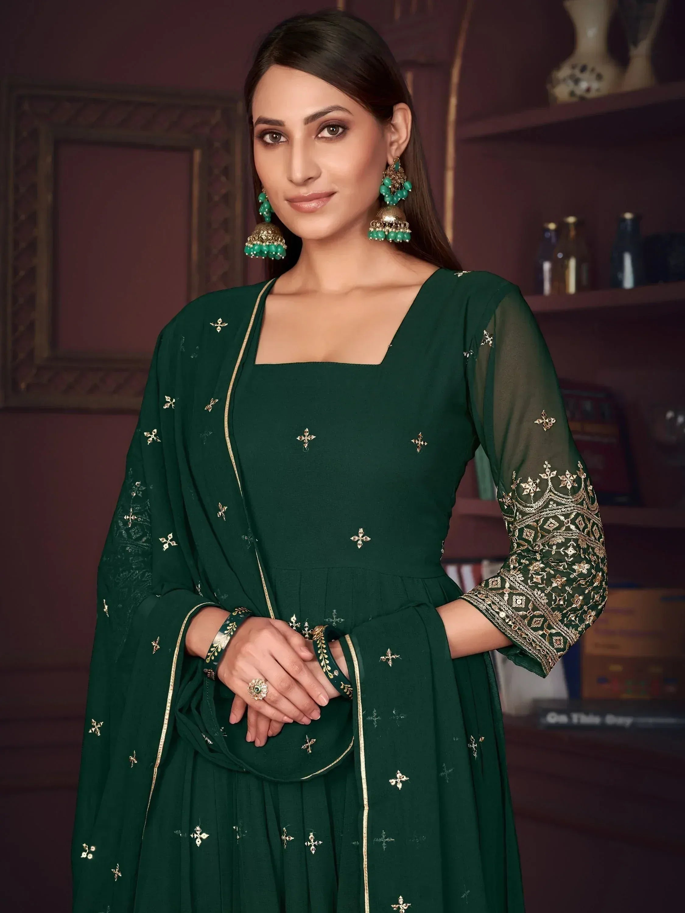 Emerald green designer salwar kameez with gold embroidery and matching dupatta, perfect for Indian ethnic wear occasions.