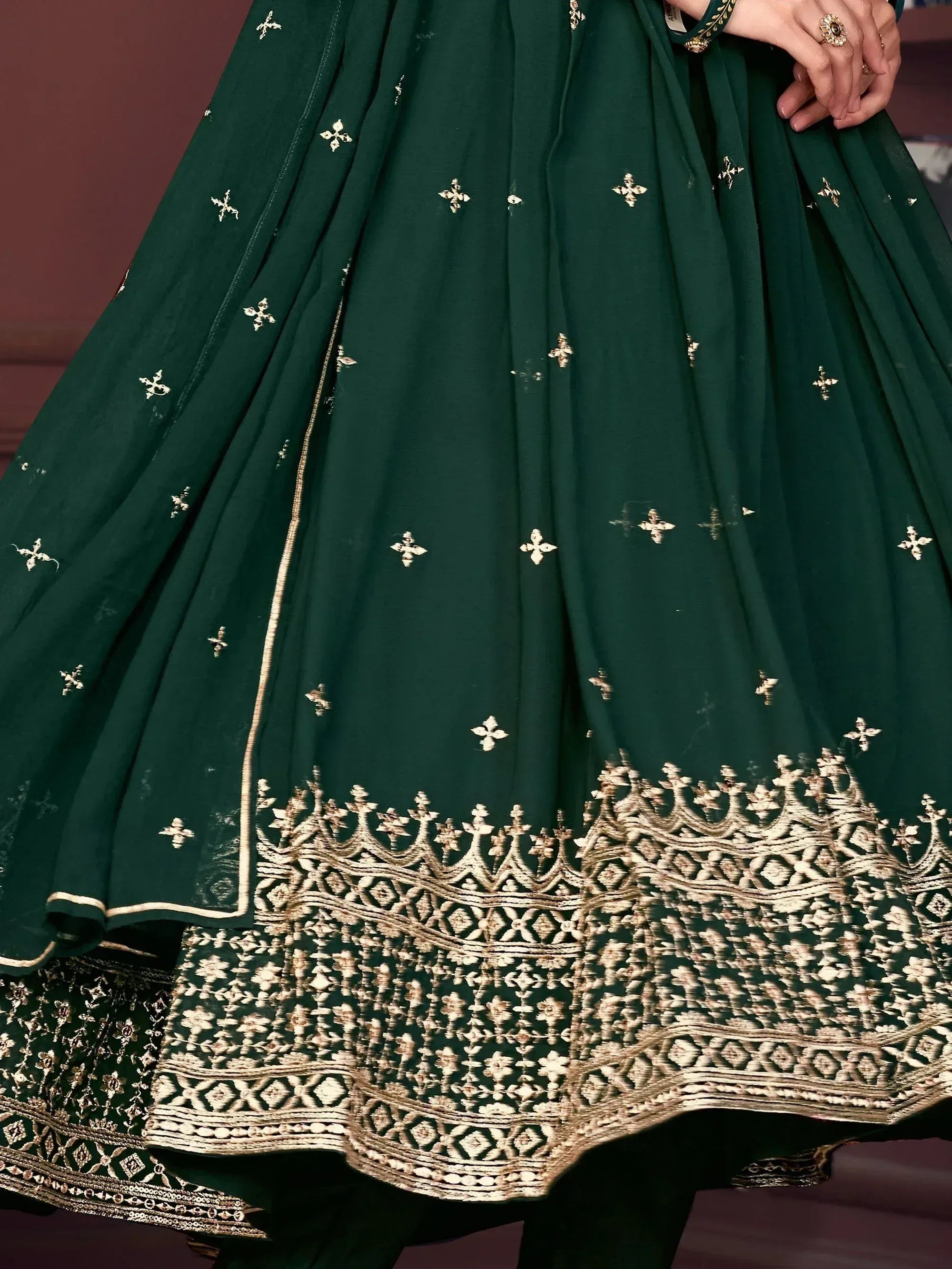 Emerald green lehenga with intricate gold embroidery and floral motifs, perfect for Indian ethnic wear.