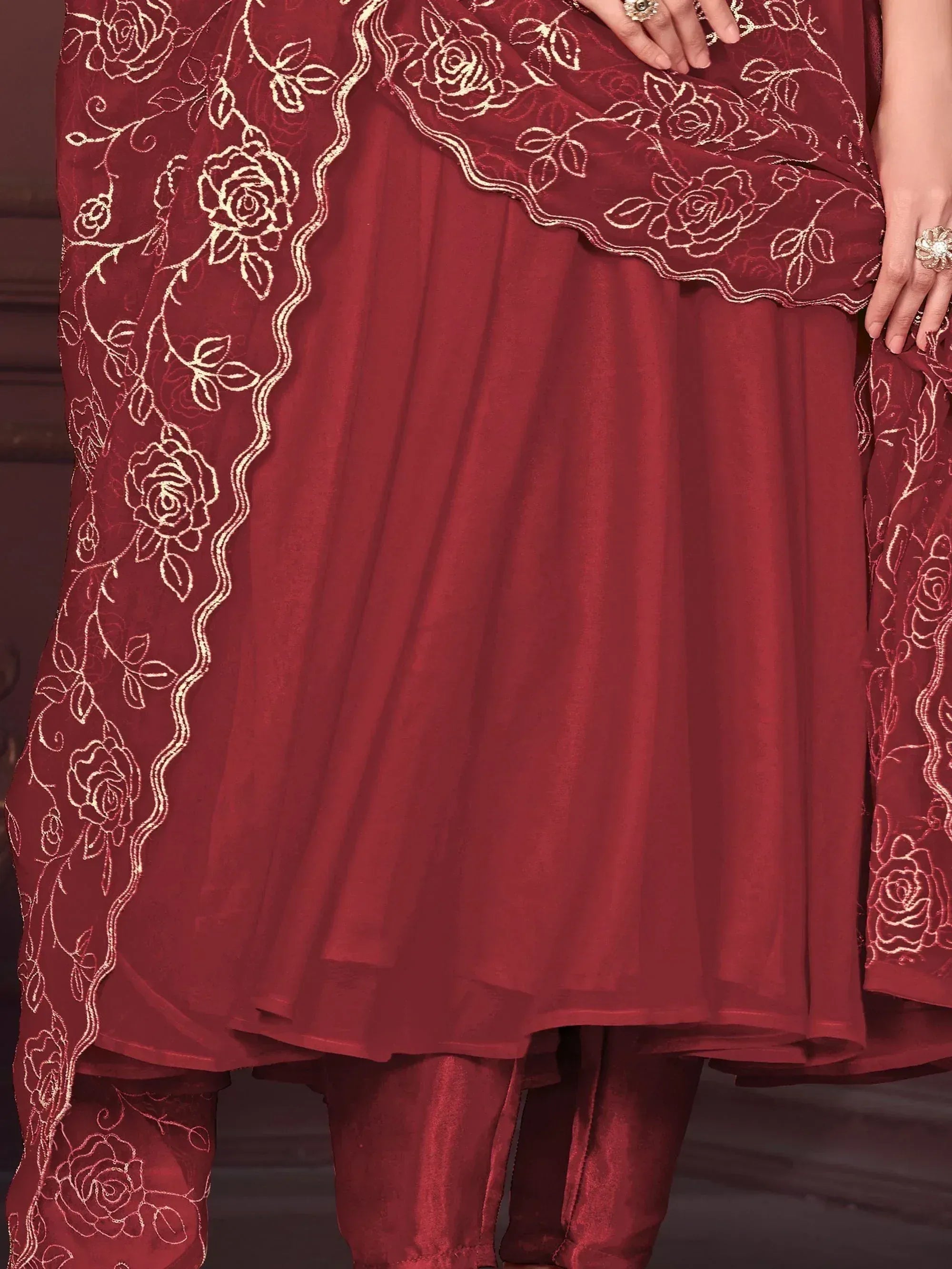Maroon ethnic salwar kameez with gold rose embroidery and sheer dupatta, perfect for festive occasions.