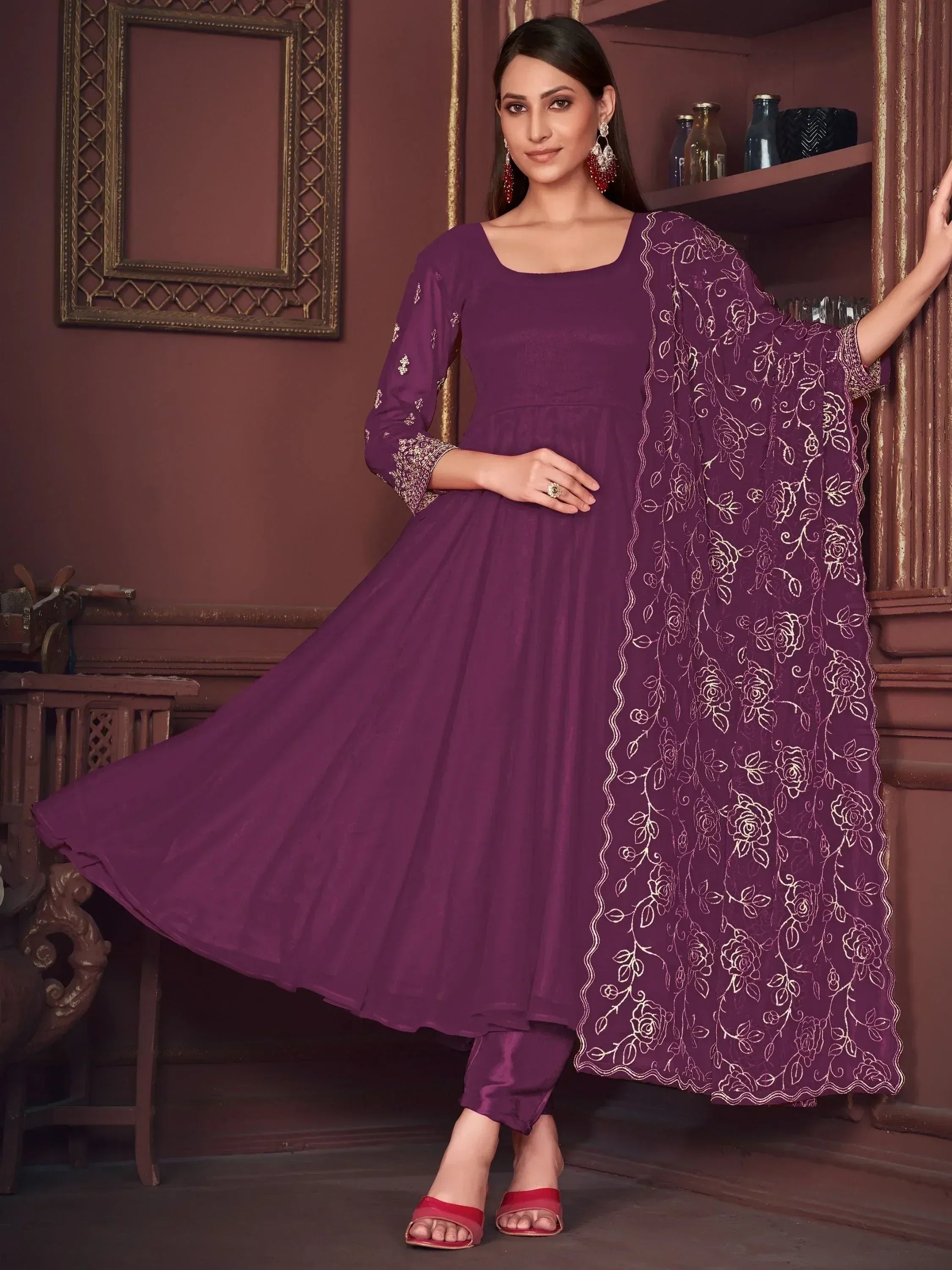 Purple anarkali suit with gold floral embroidery, paired with matching pants and dupatta, perfect for ethnic occasions.