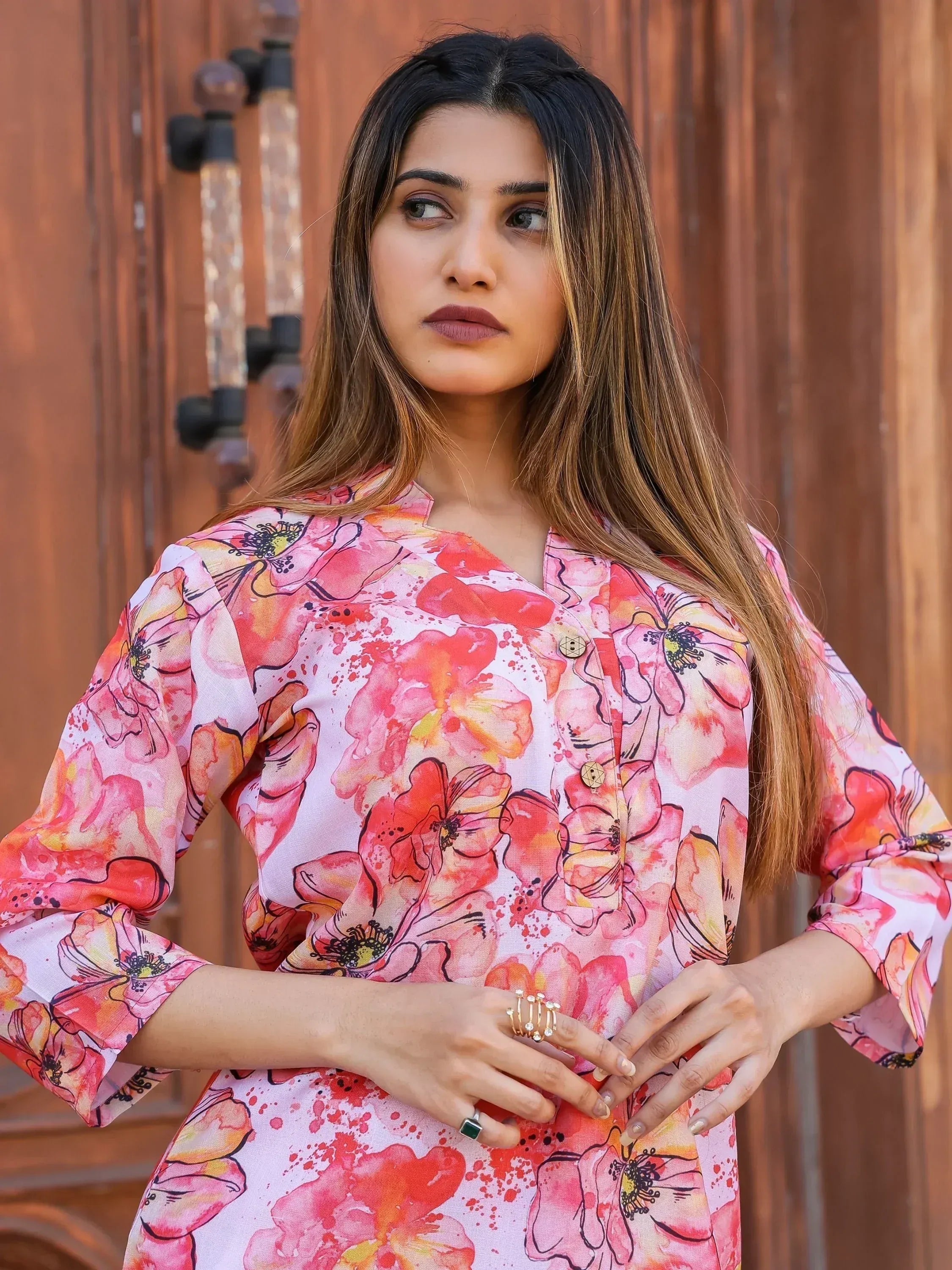 Woman in vibrant floral print ethnic kurta with bell sleeves, perfect for Indian festive wear