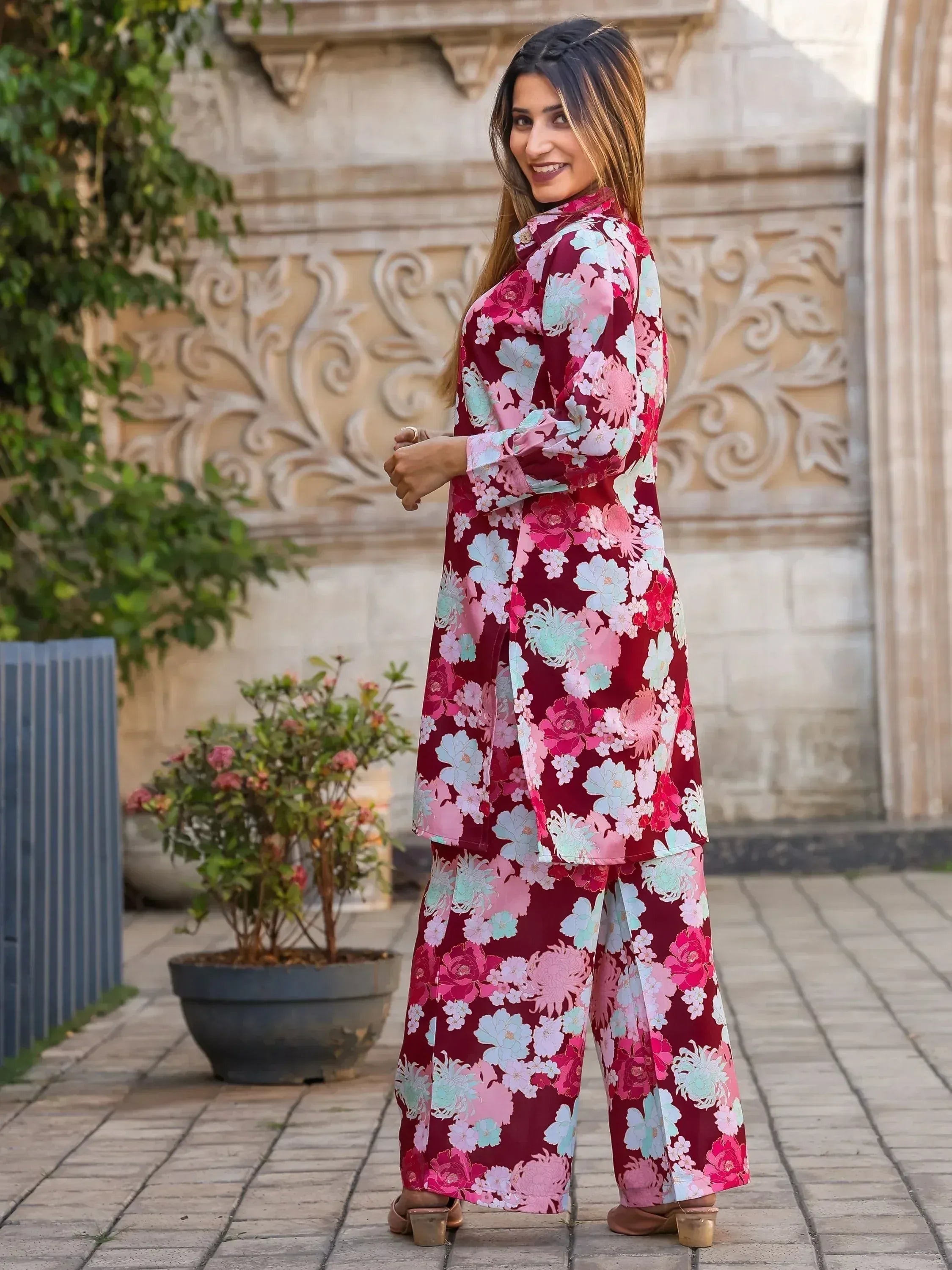 Woman in maroon floral print salwar kameez with wide pants, perfect for ethnic occasions