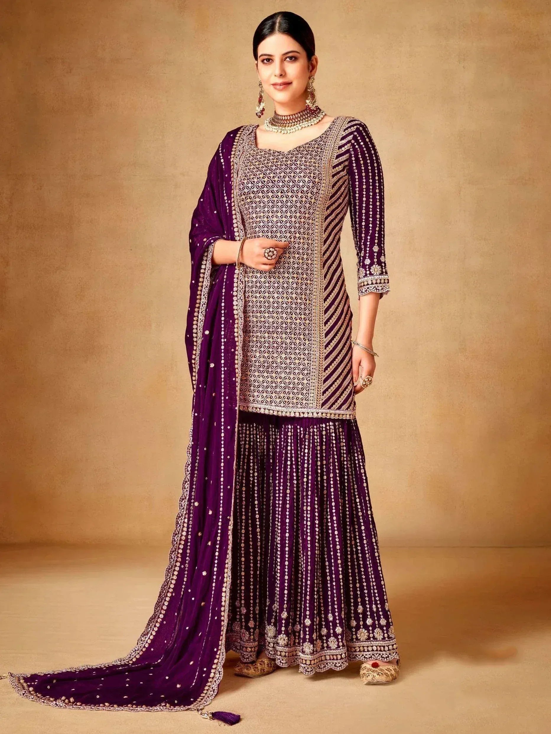 Elegant purple ethnic sharara suit with intricate gold embroidery and matching dupatta for festive occasions