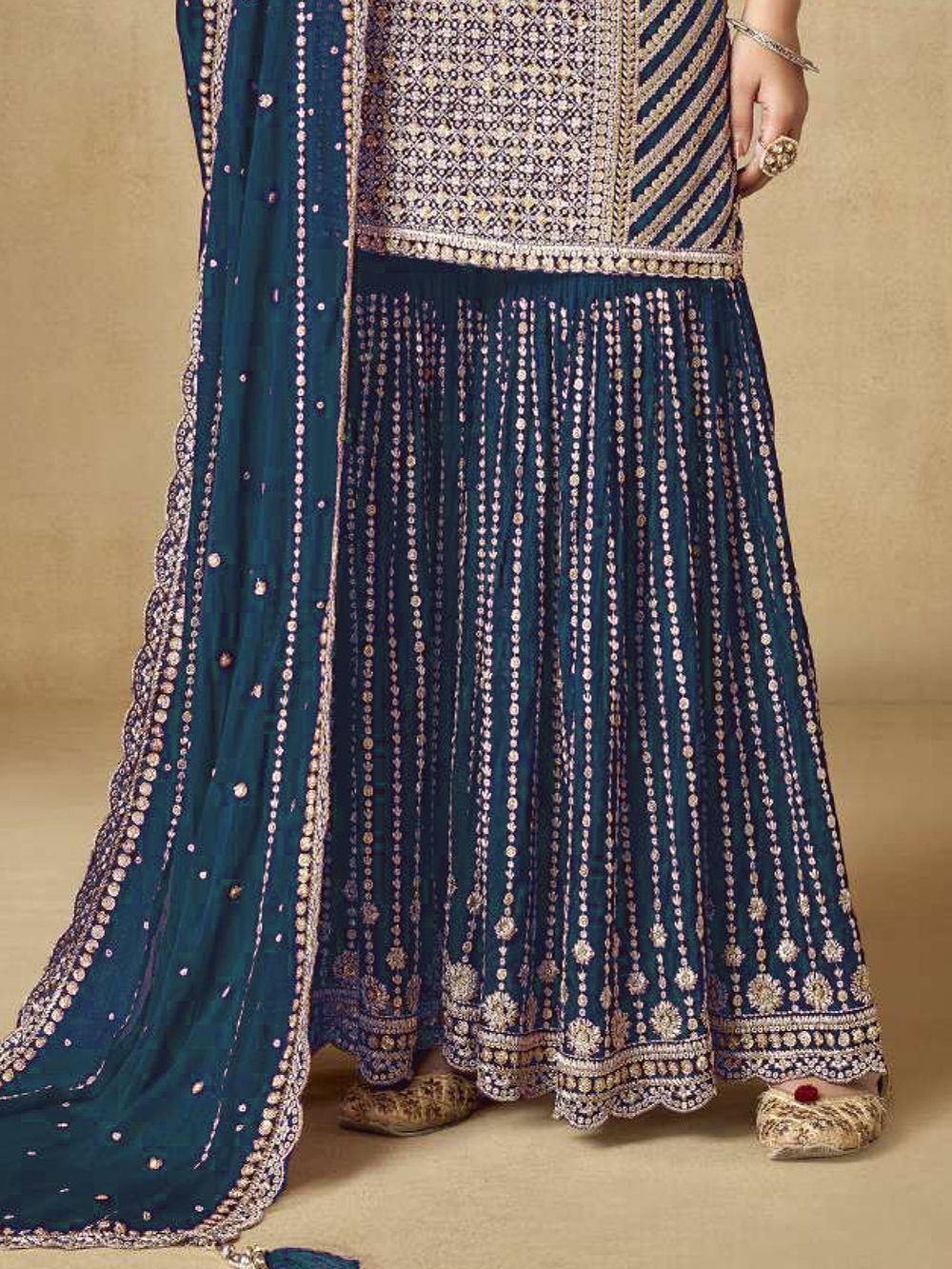 Teal blue embroidered lehenga choli with gold detailing and matching dupatta, perfect for Indian ethnic wear occasions.