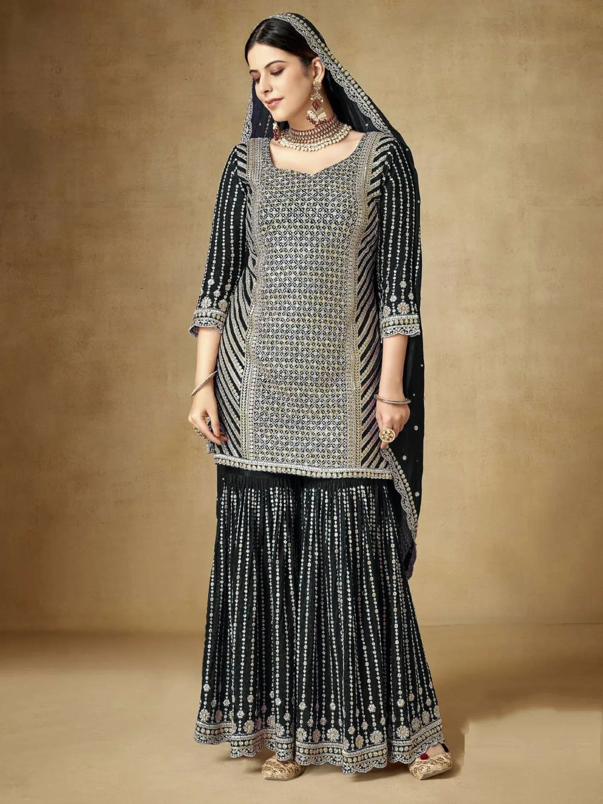 Elegant black embroidered salwar kameez with intricate detailing and matching dupatta for ethnic wear