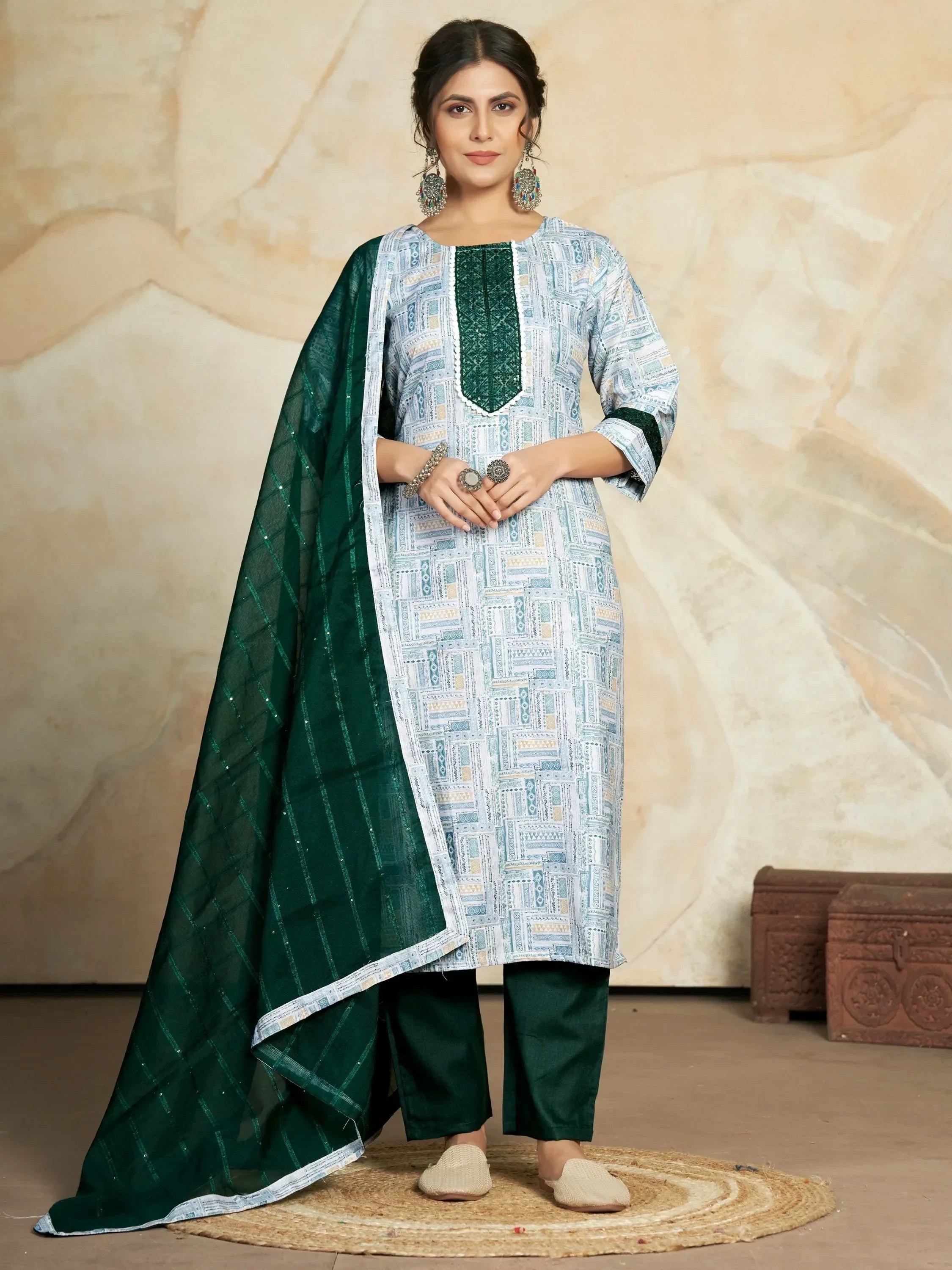 Woman wearing green and white printed salwar kameez with matching dupatta and jewelry