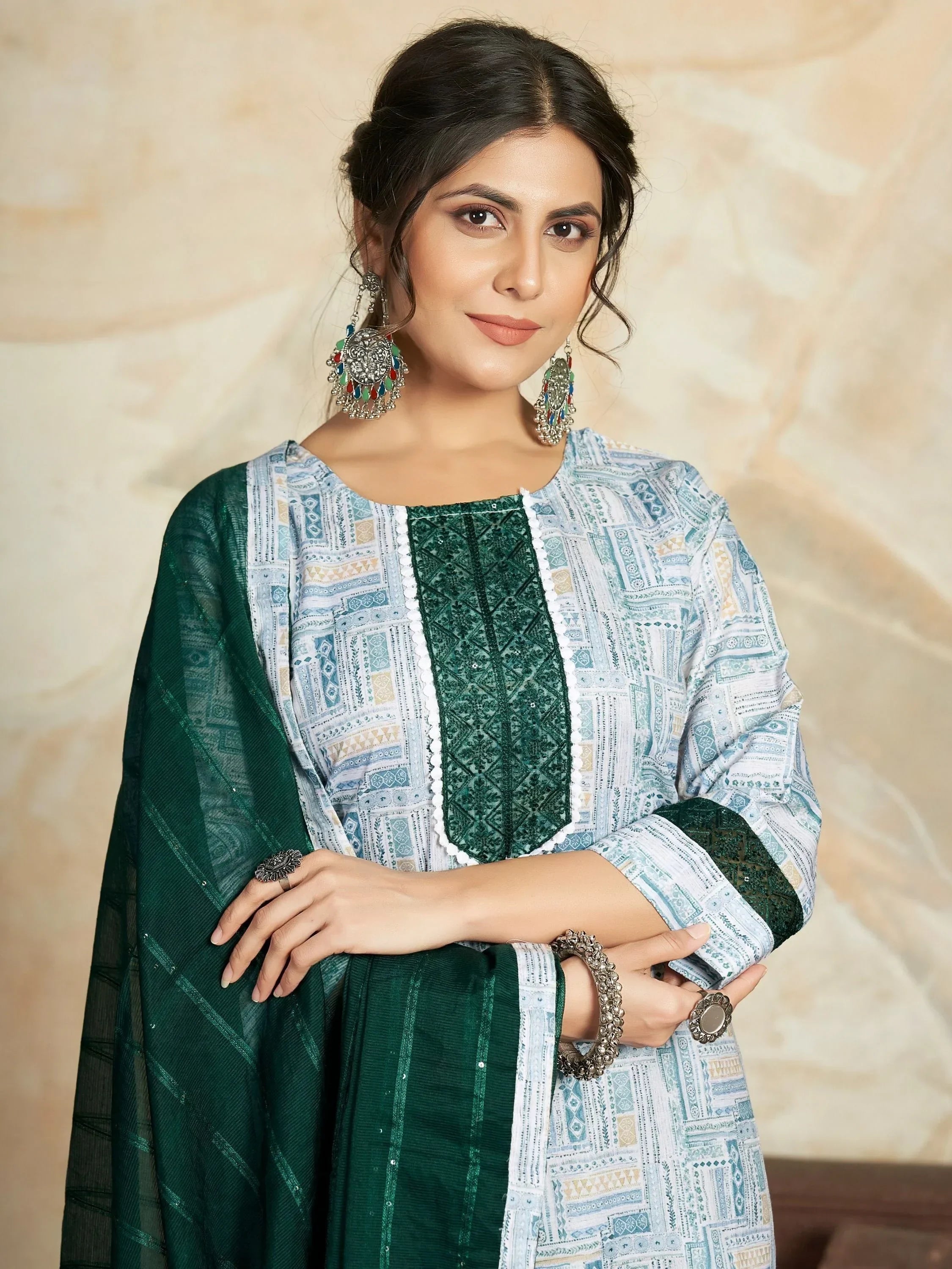 Woman in green and white printed ethnic salwar kameez with matching dupatta and statement earrings