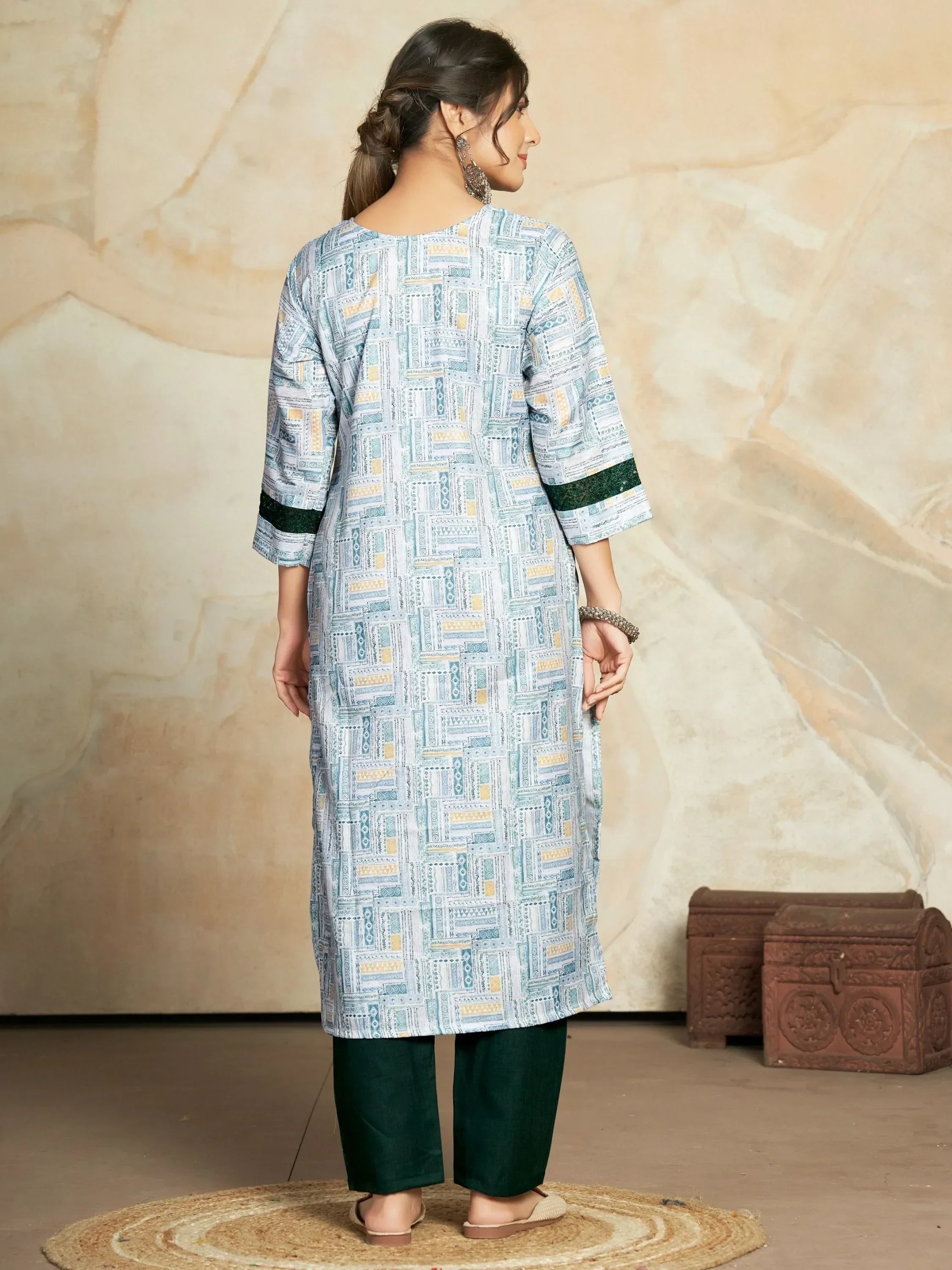 Woman in printed straight kurta with three-quarter sleeves and dark green pants, back view