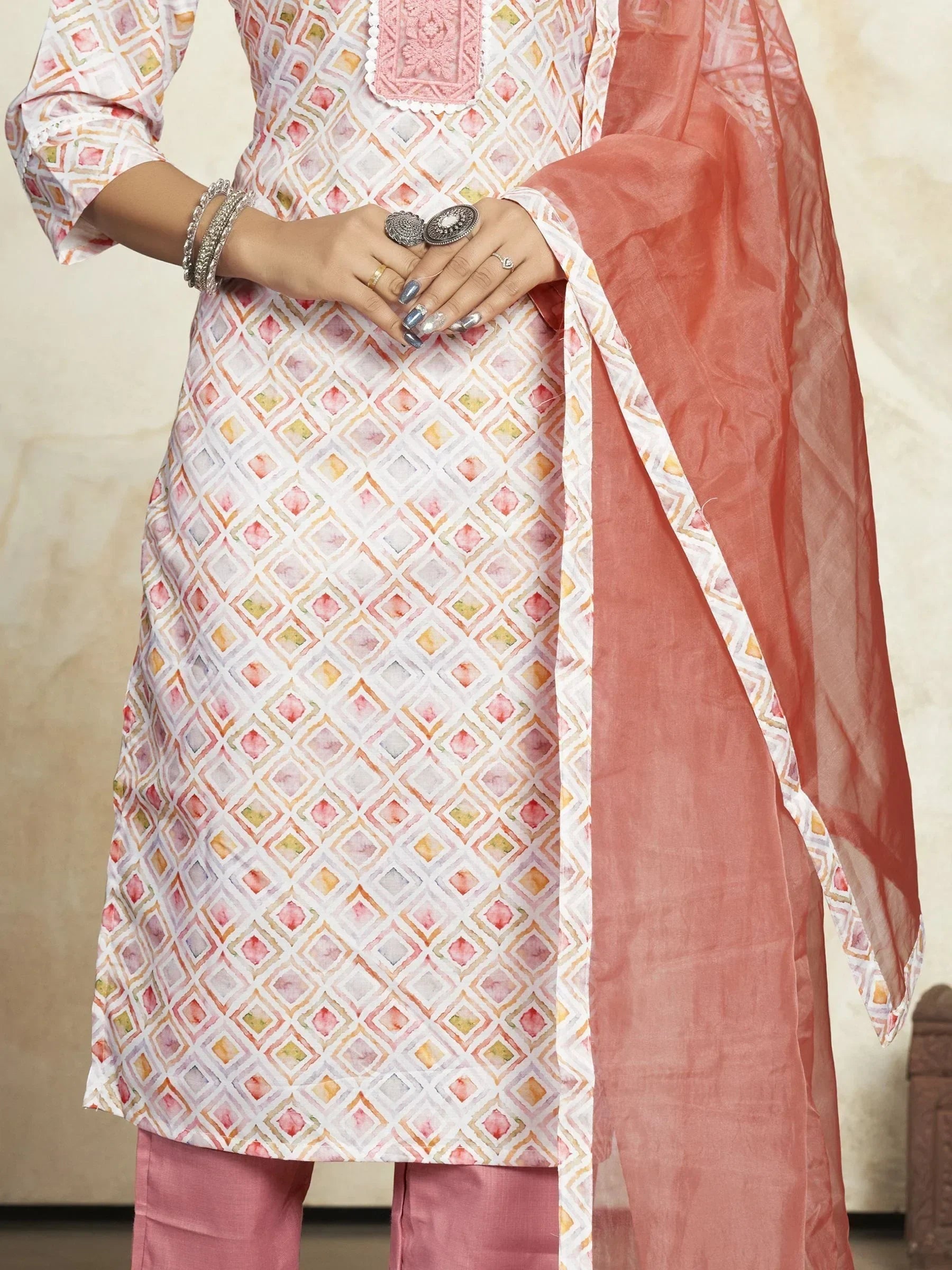 Women's pastel geometric print kurta set with pink dupatta and silver jewelry