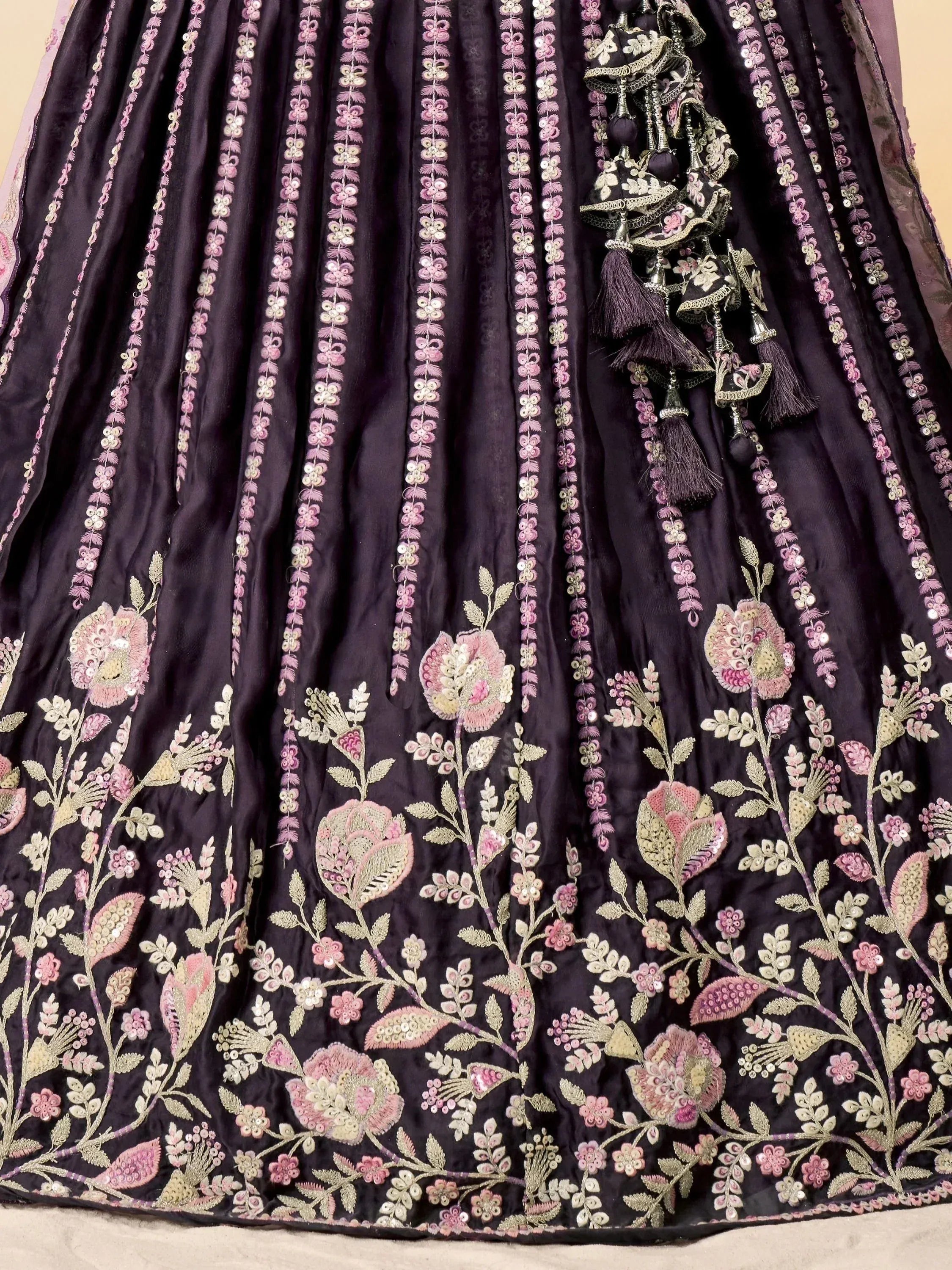 Elegant black lehenga with pink floral embroidery, sequins, and tassels for Indian ethnic wear